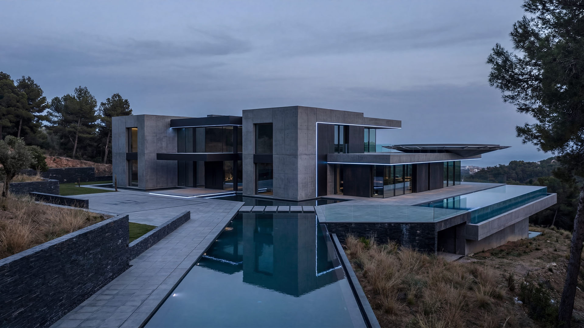 Contemporary luxury villa in Marbella with infinity pool, geometric architecture, and mountain surroundings at dusk