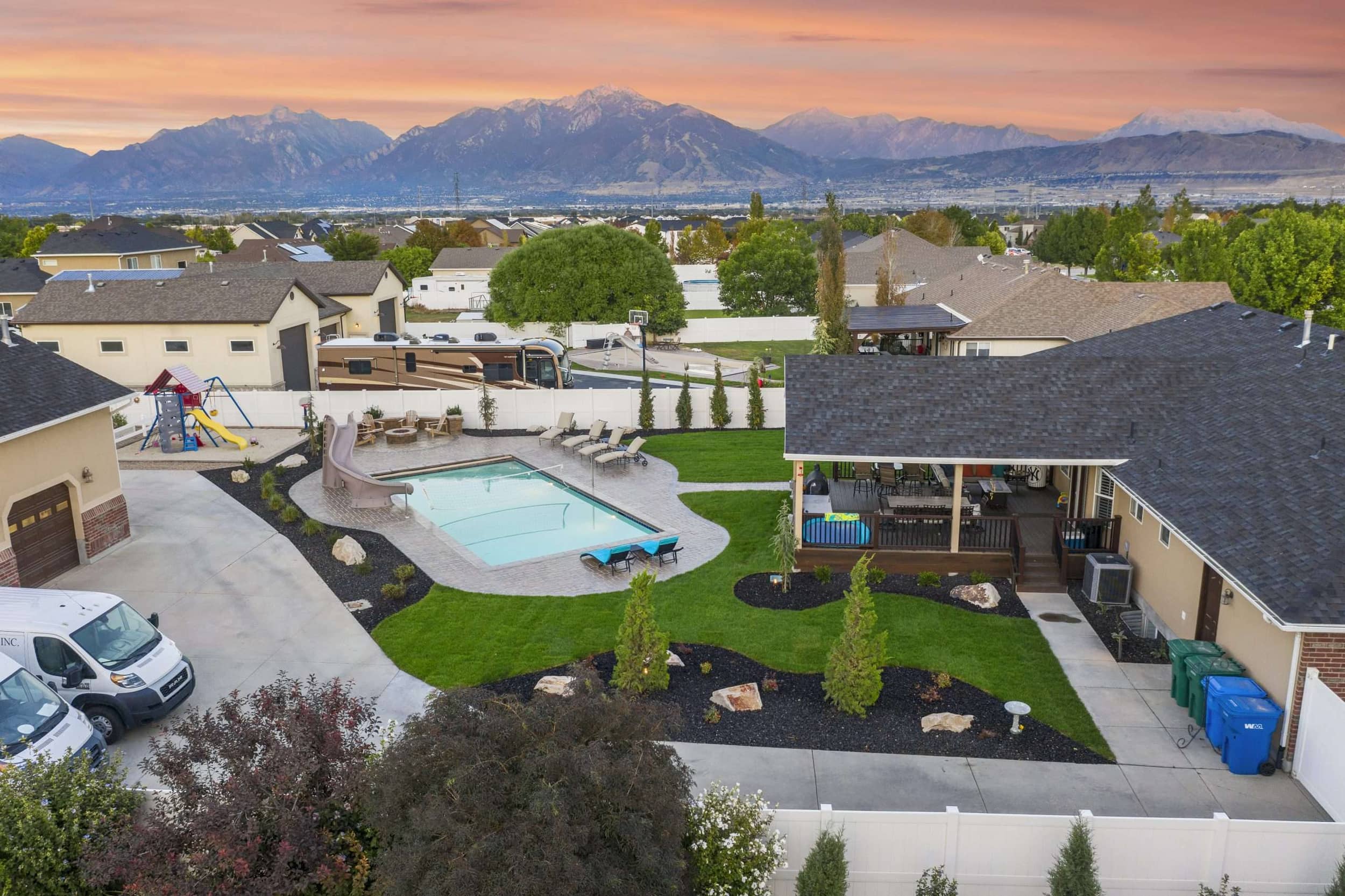 Riverton Residence backyard pool and patio framed by sweeping Wasatch mountain views