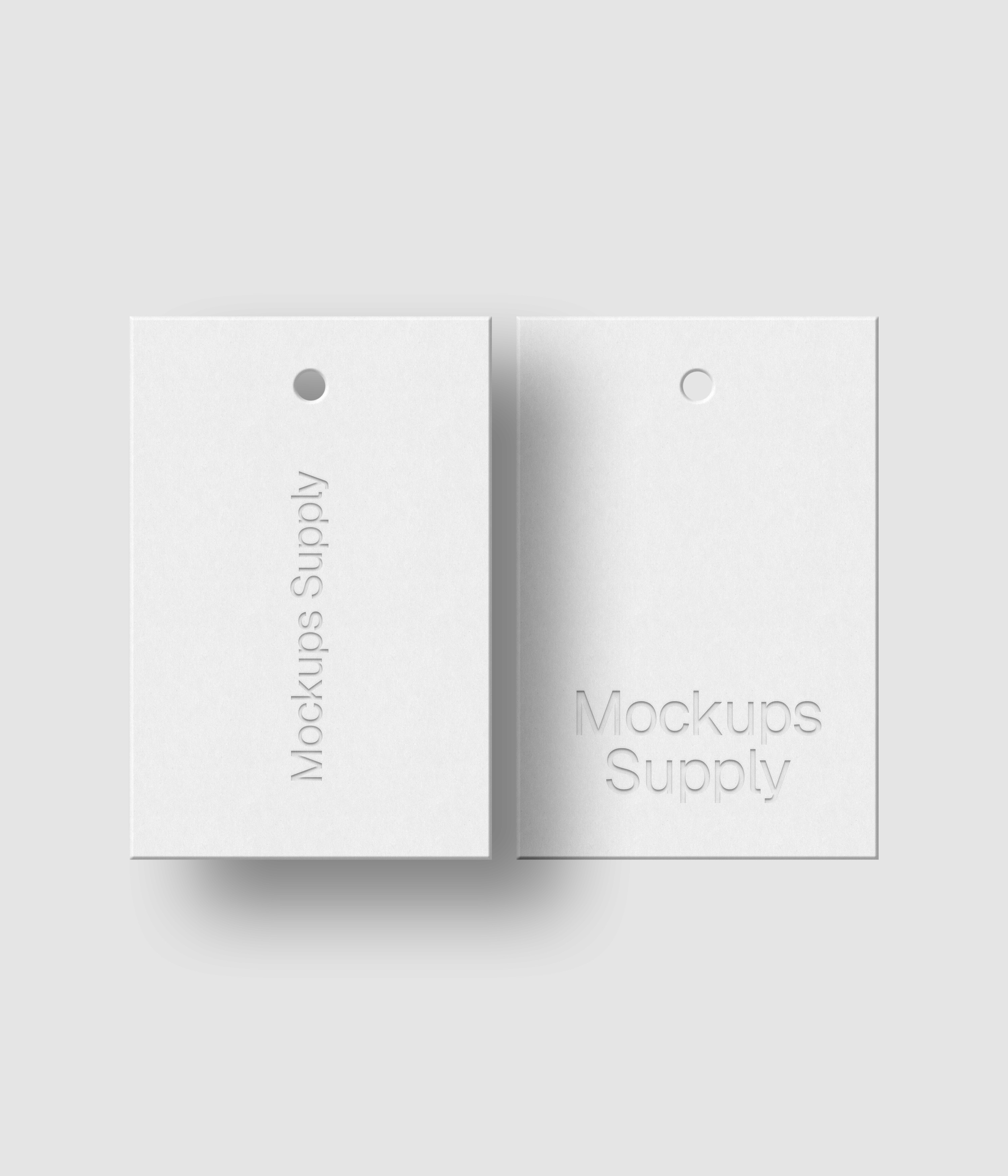 Two white 2x3 hang tags mockup on white background with realistic debossed logo effect and soft shadow for Photoshop download psd