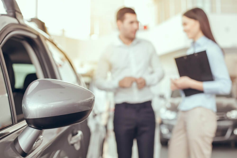 Person showing documentation to potential vehicle buyer