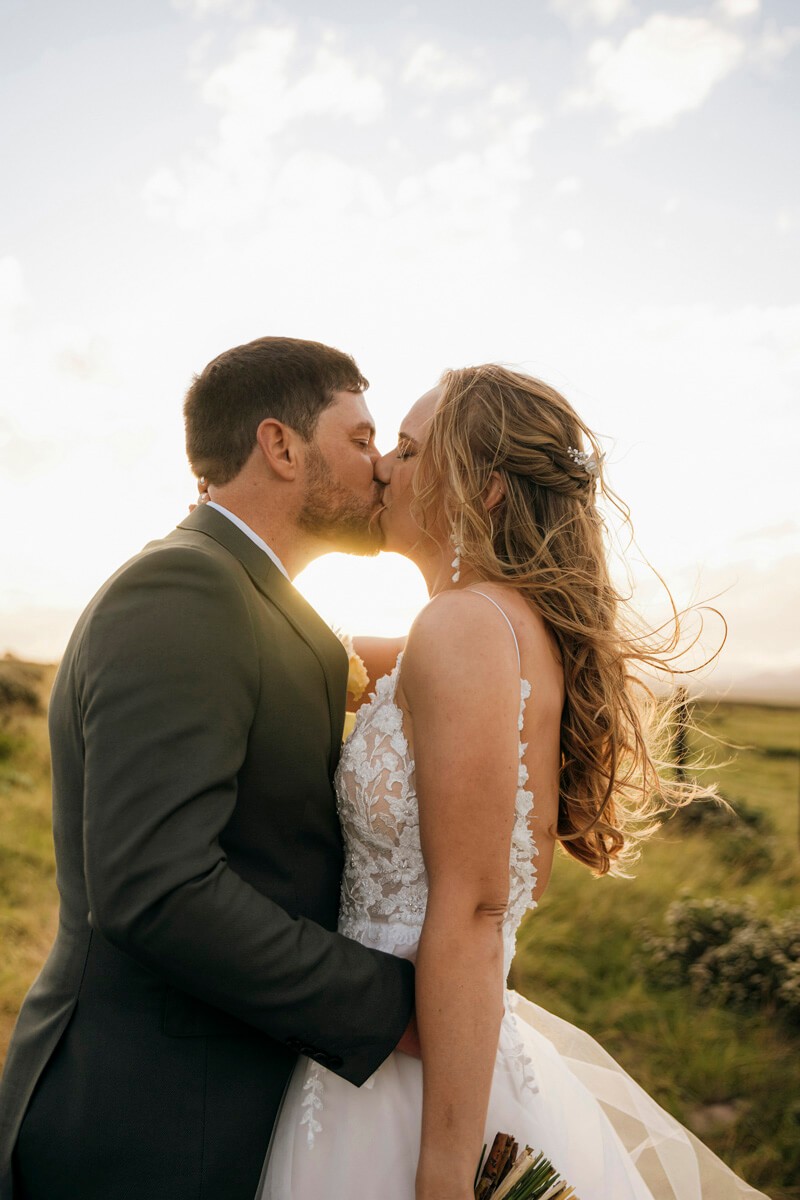 Bride and groom kissing at sunset during Eastern Cape estate wedding