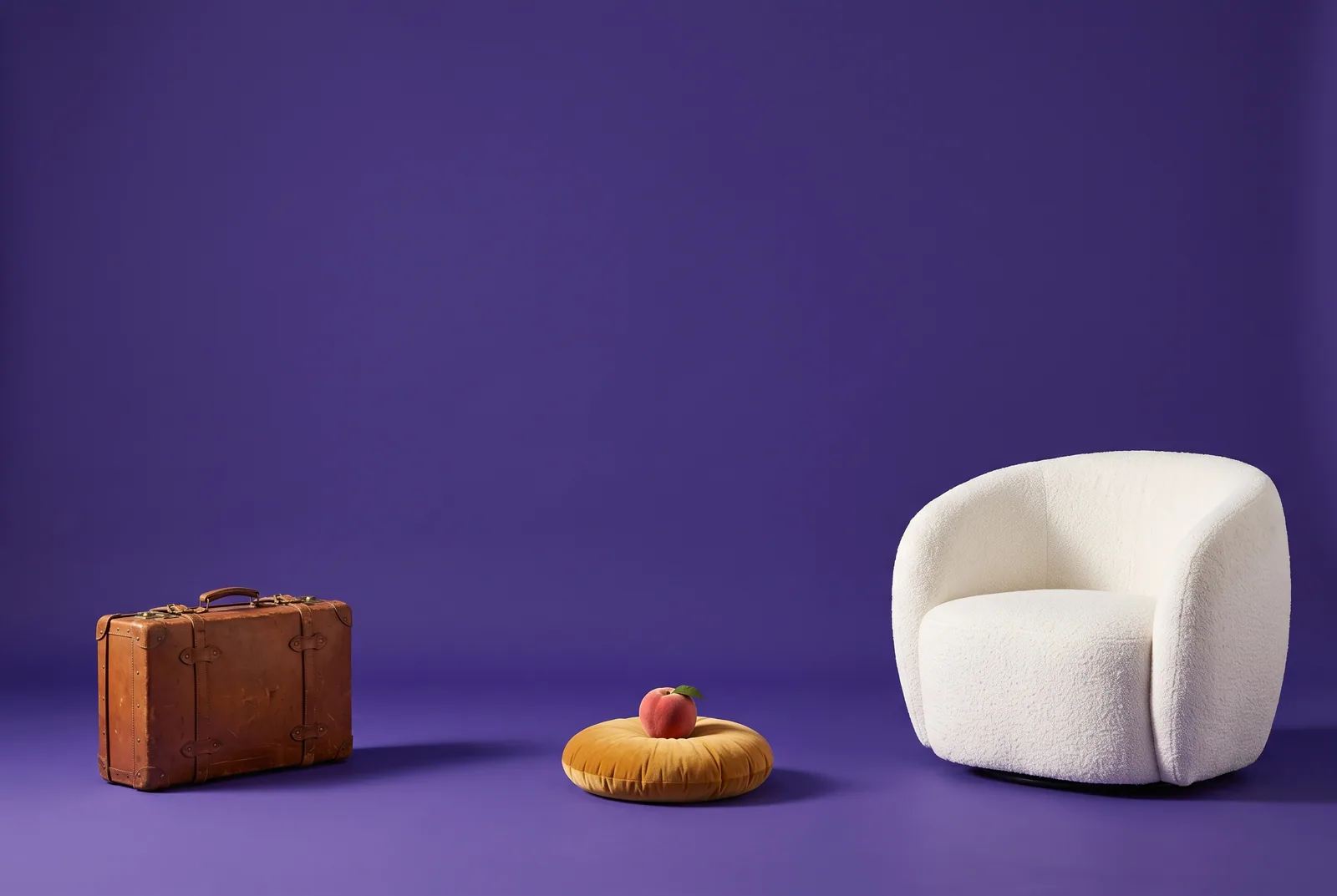 A peach on a cushion between a packed suitcase and an armchair, should you stay or leave, a question for wives of porn addicts