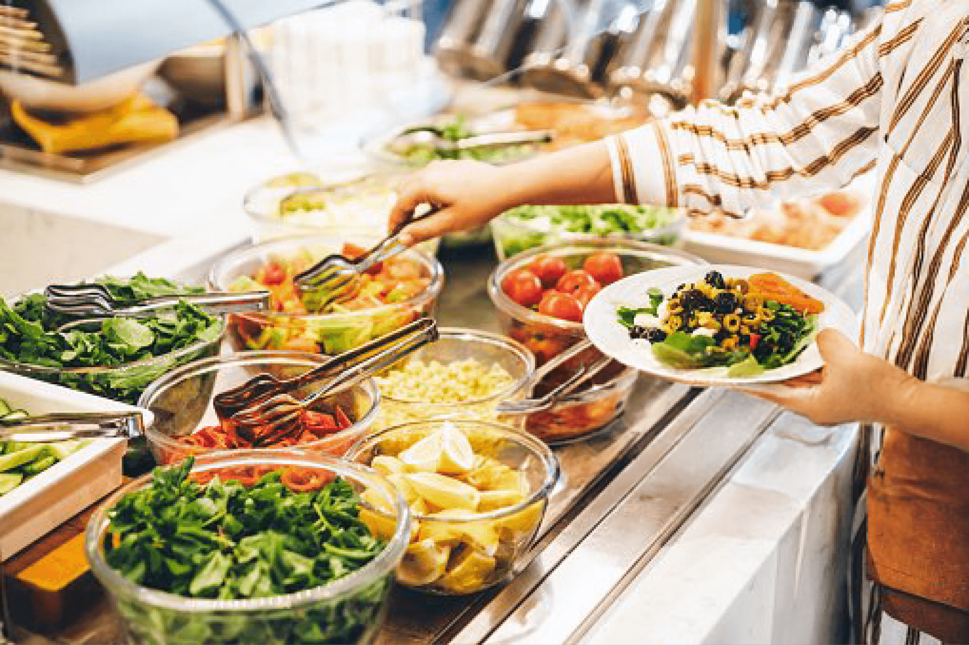 Salad bar with fresh greens and vegetables, promoting healthy eating during celebrations.