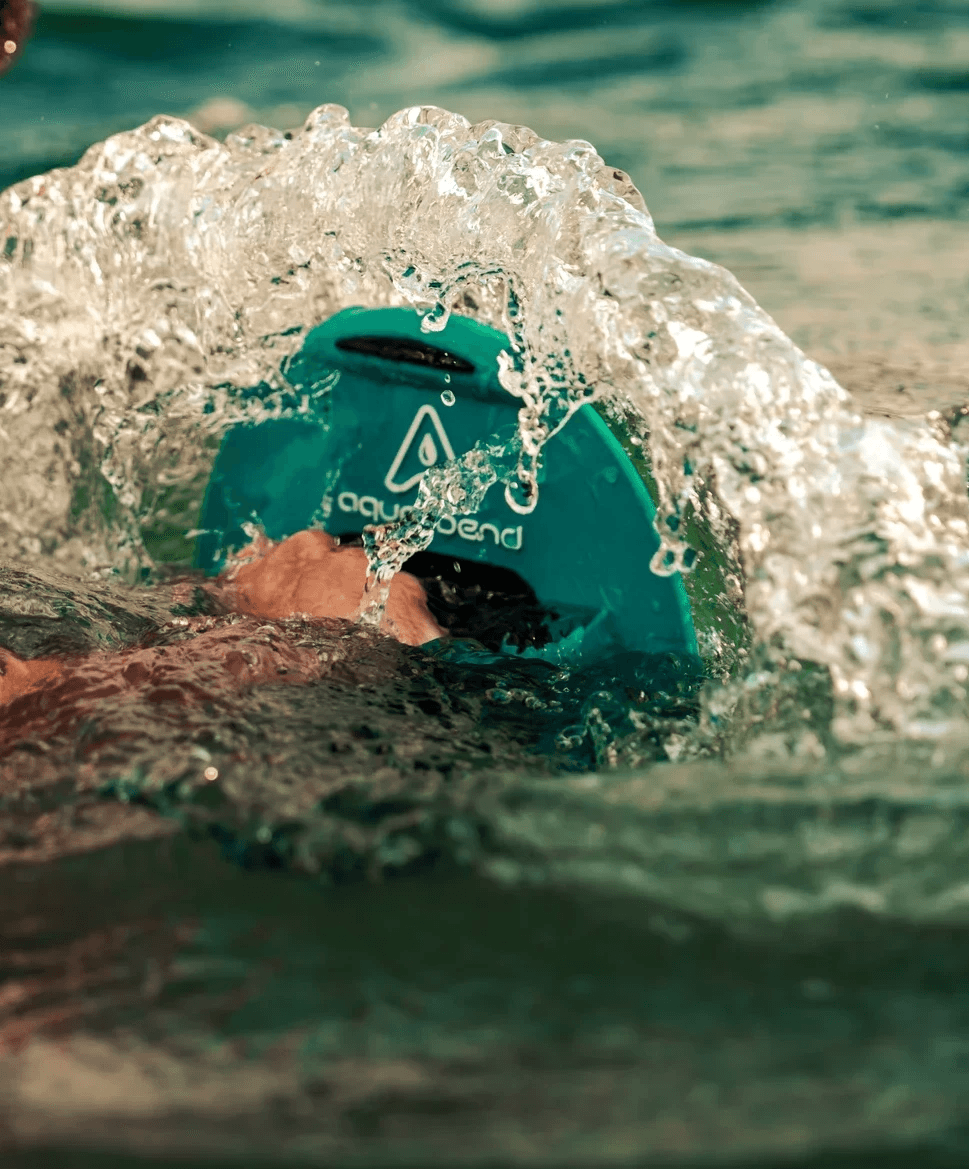 Close-up of hand gripping Aqua-Bend disc during chest press, water rippling over the disc from resistance
