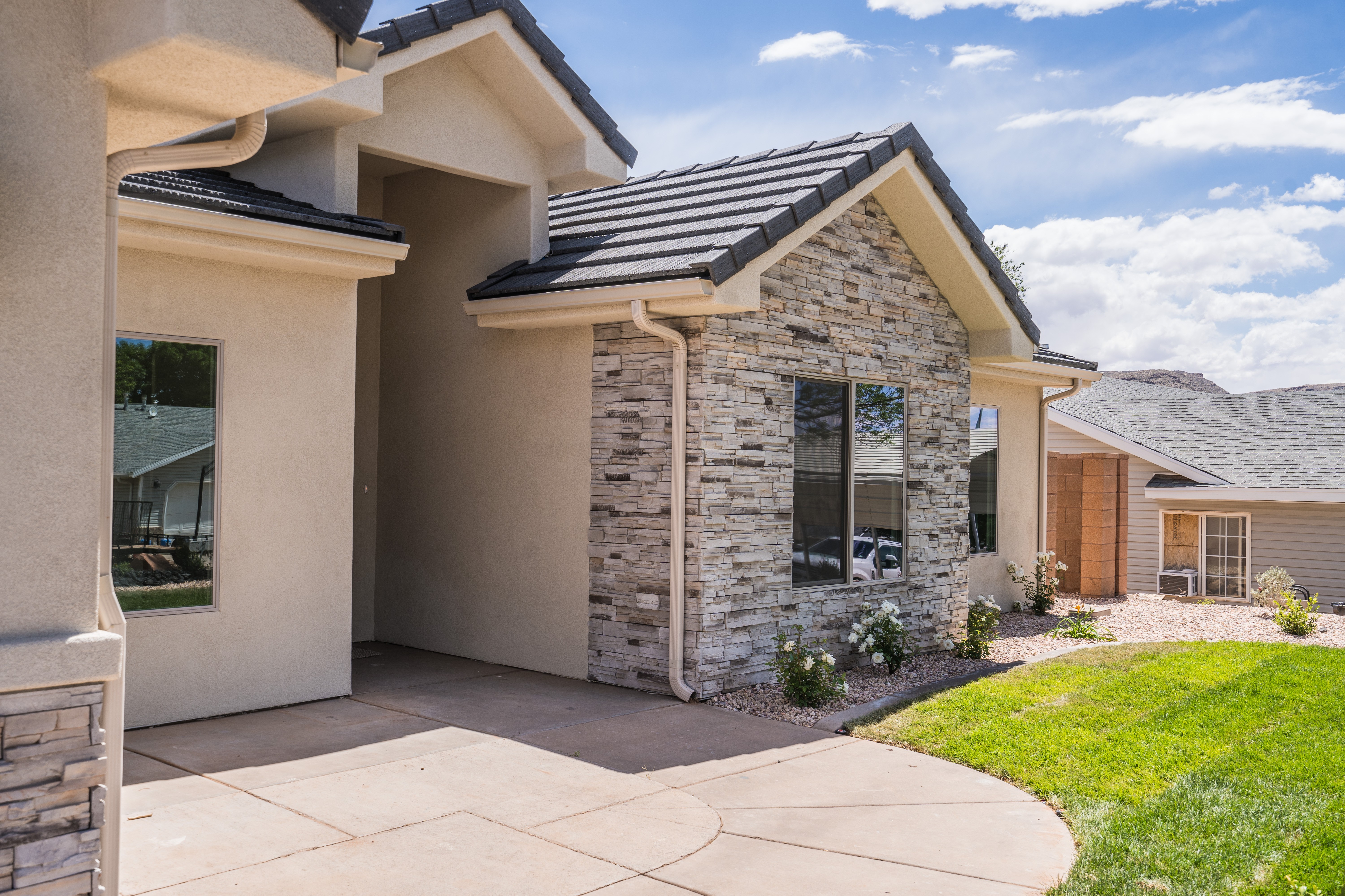 Exterior detail of a remodeled home in Southern Utah with stone and stucco combination.