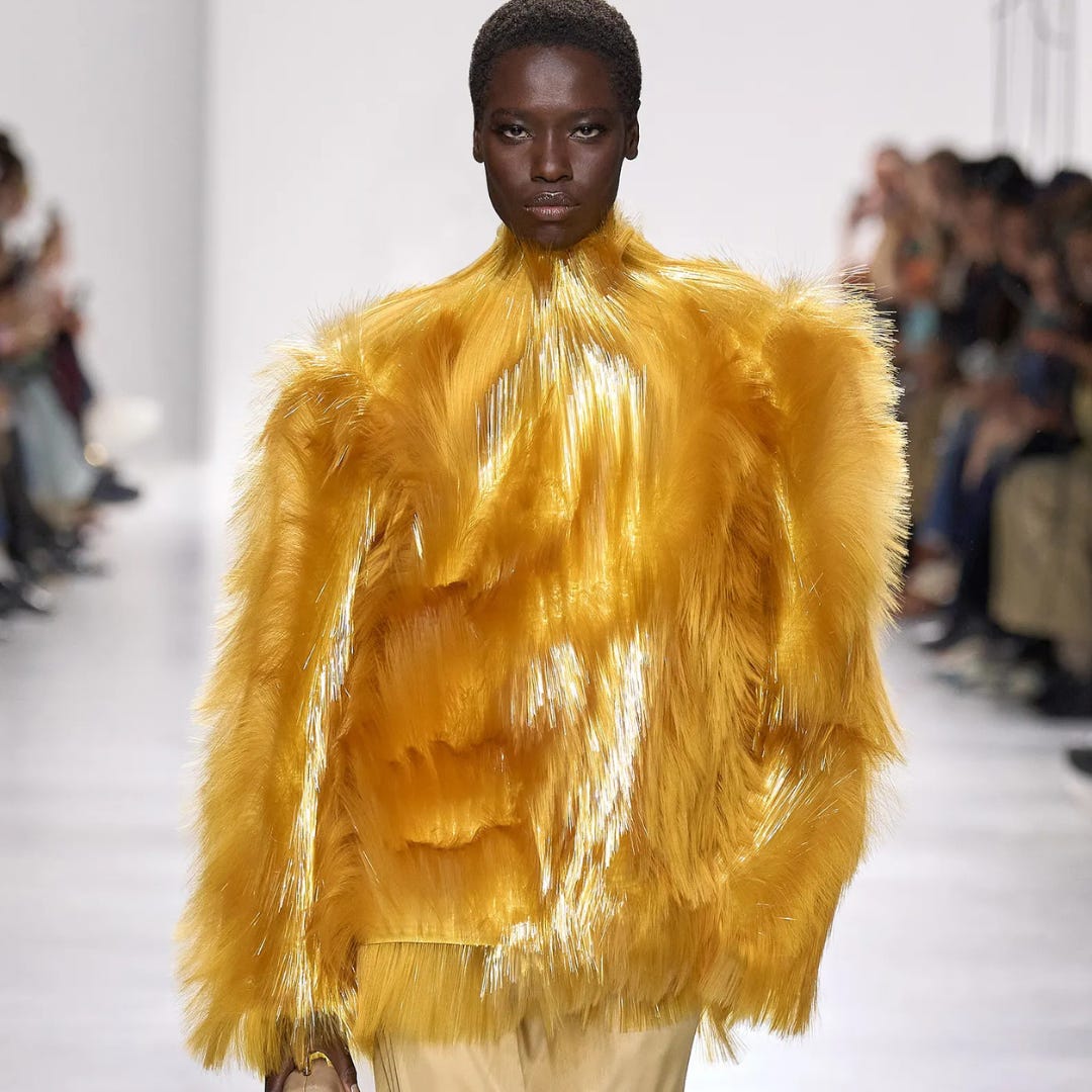 Person in a white off-shoulder top using a MacBook laptop, with text overlay 'What's new in digital?' and the fabrica® logo in the top corner.