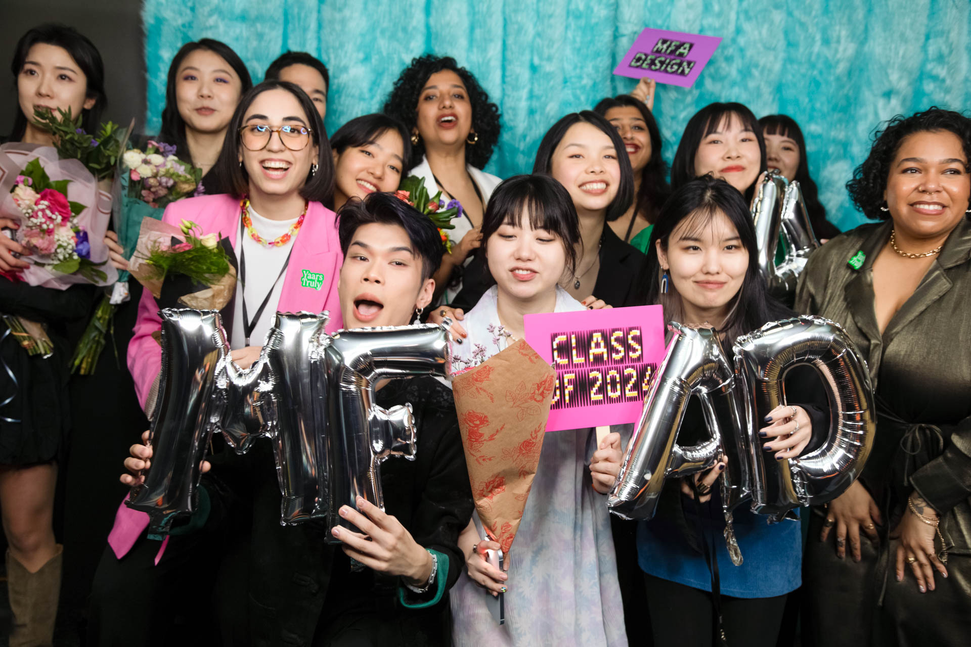 a group of students smiling for the camera in the SVA Theatre lobby after the Venture Forum