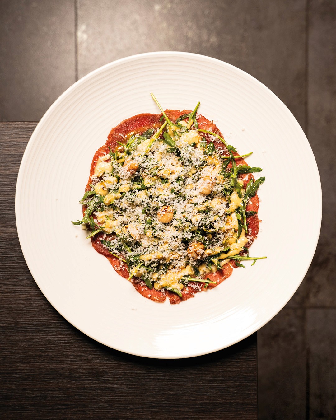 „Rindercarpaccio mit frischem Rucola, gehobeltem Parmesan und einer leichten Zitronenmarinade – klassisch italienische Vorspeise im Ristorante Giuseppe Gentile.“