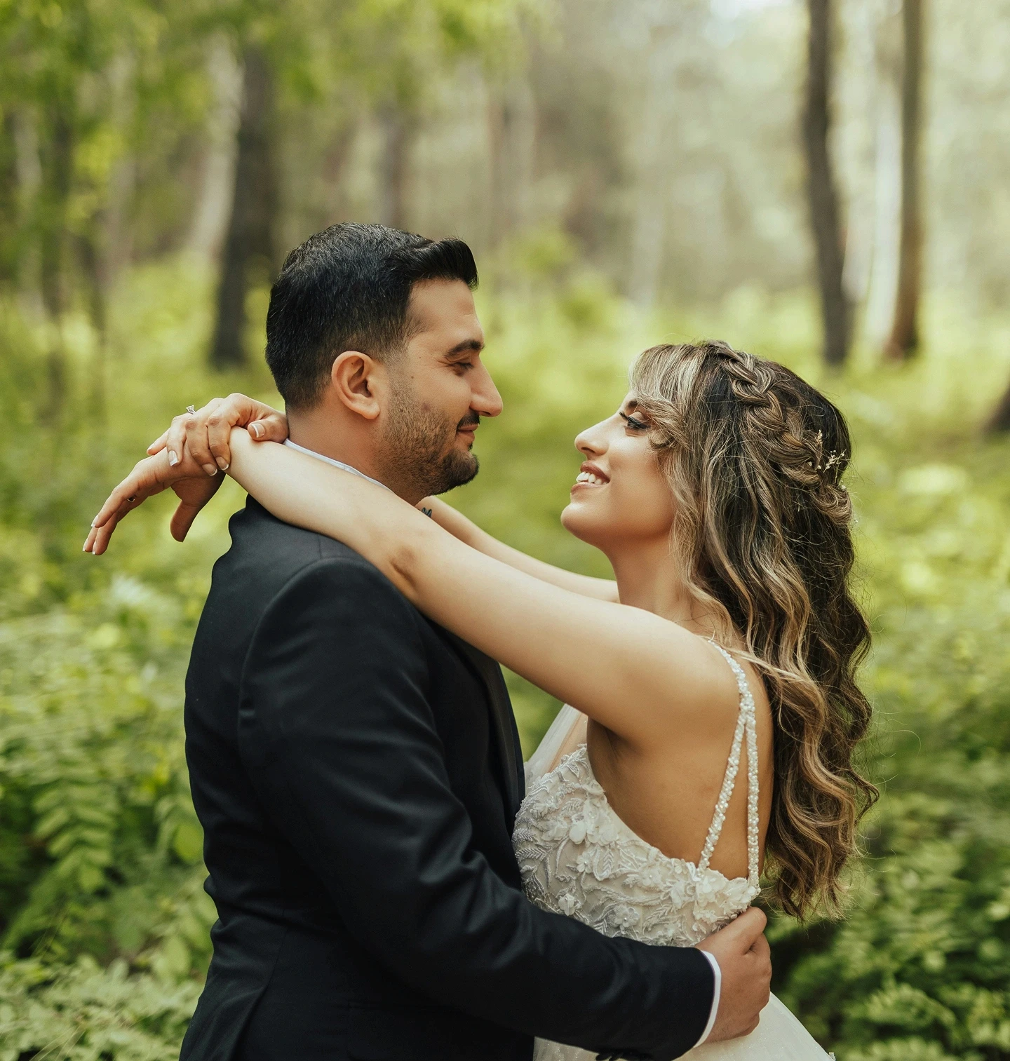 Bride and groom sharing a romantic moment in the forest