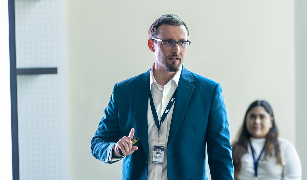 Co-founder Ryan Adams in business suit presenting