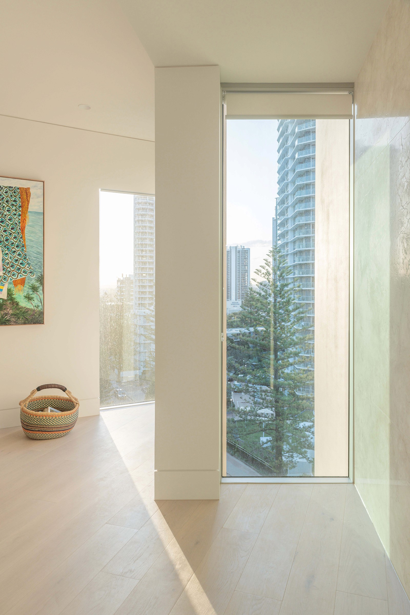 High Tide apartment interior with floor-to-ceiling glazing, soft natural finishes, and coastal city views in Surfers Paradise.