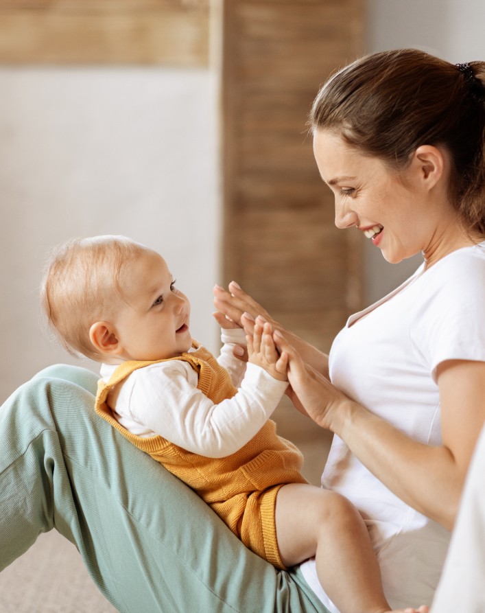 mom holding baby and smiling