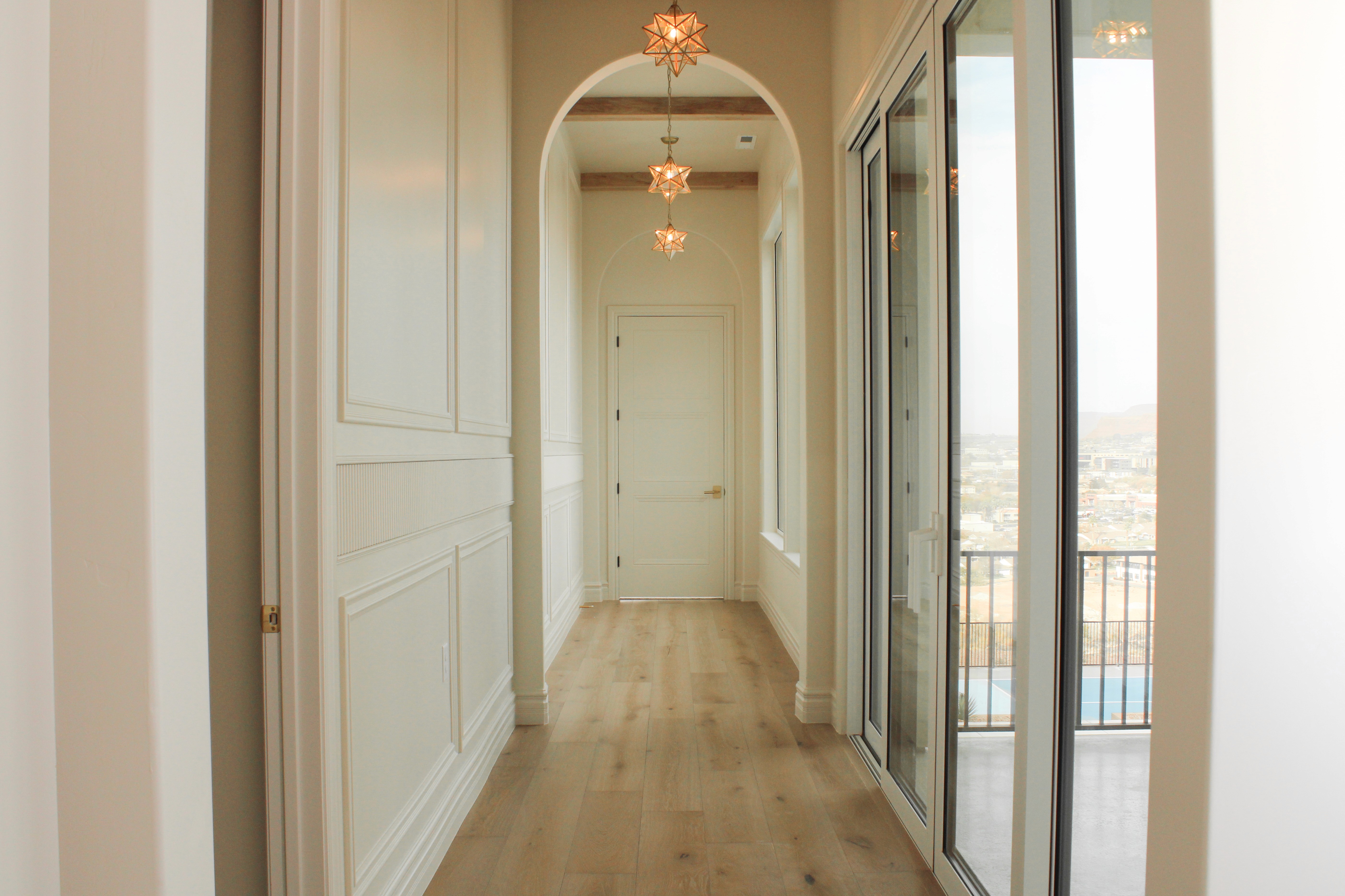 Custom home in St. George, Utah with arches with light fixtures and beams.
