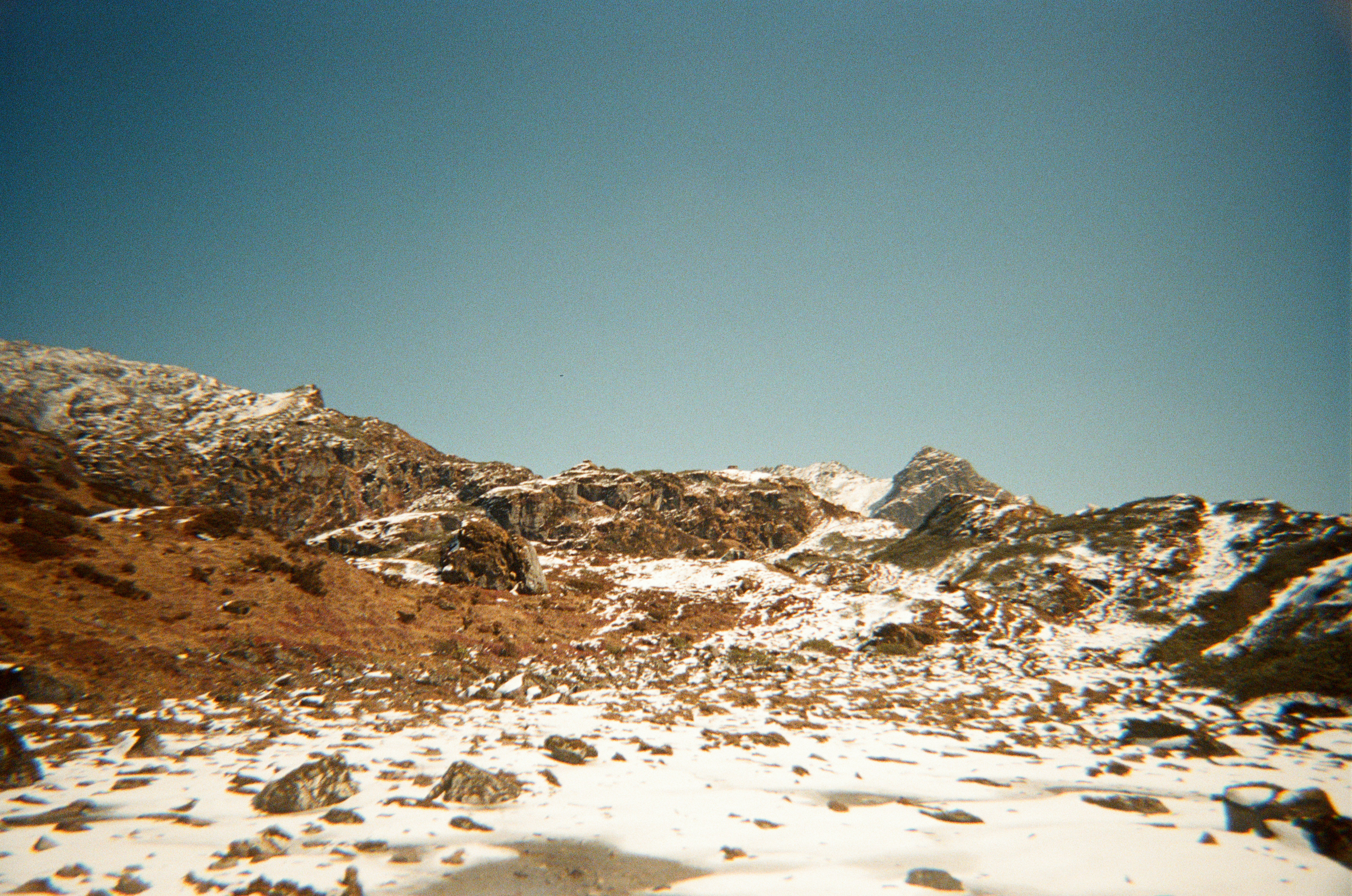 Snowy mountain landscape under a clear blue sky