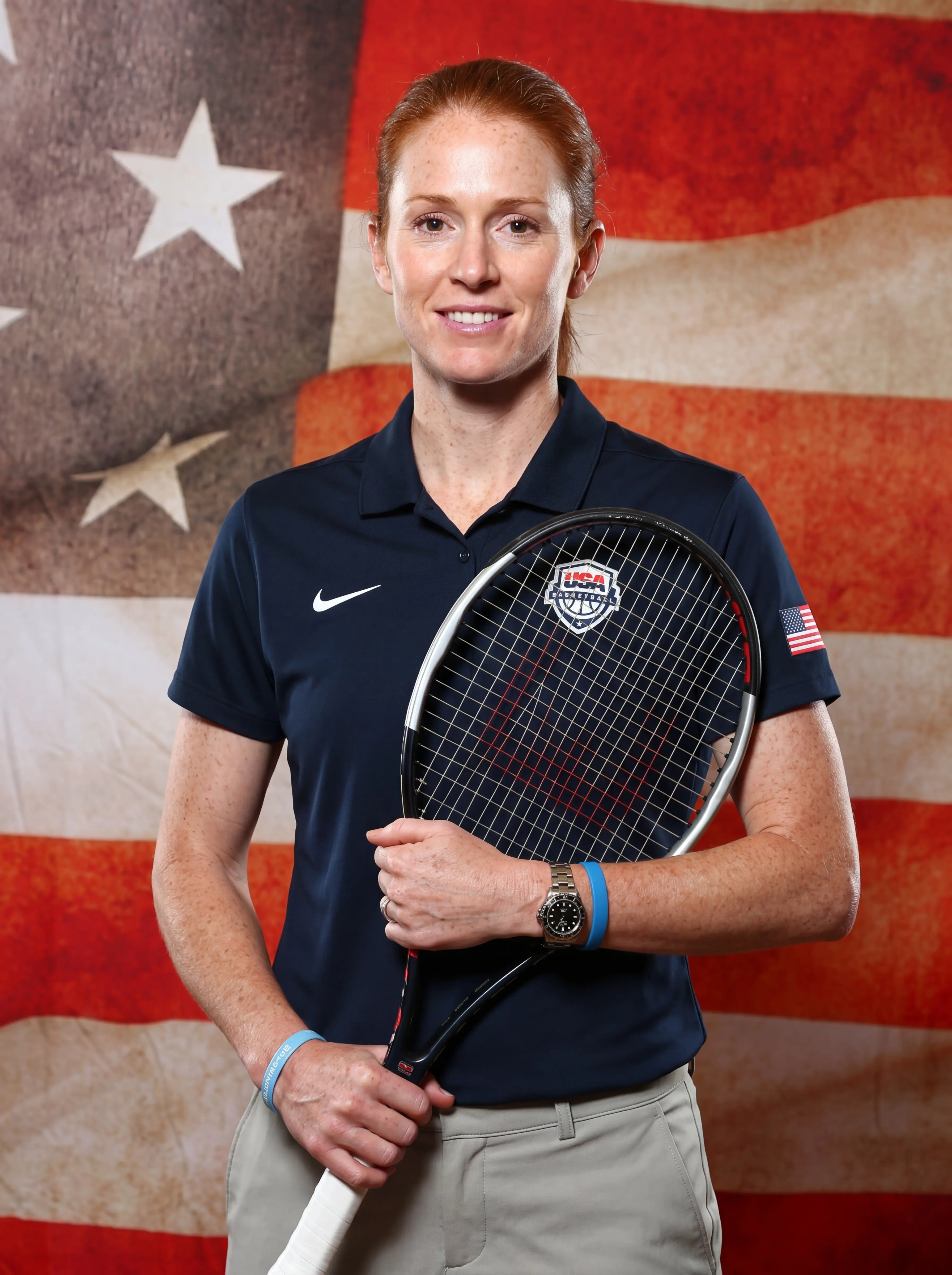 Portrait photo of a sports coach infront of USA Flag