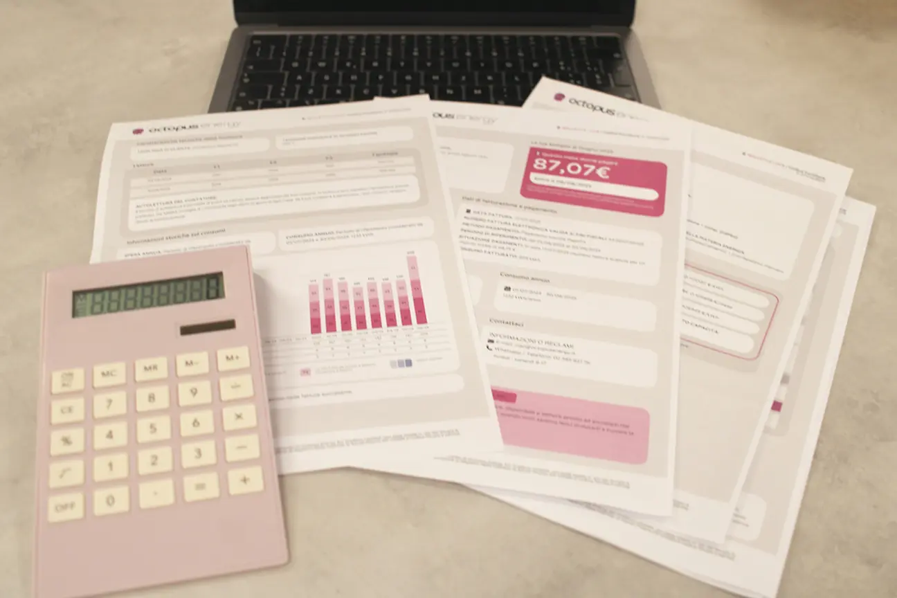 Laptop, calculator, and paperwork, symbolizing managing a loan payment log and balance.