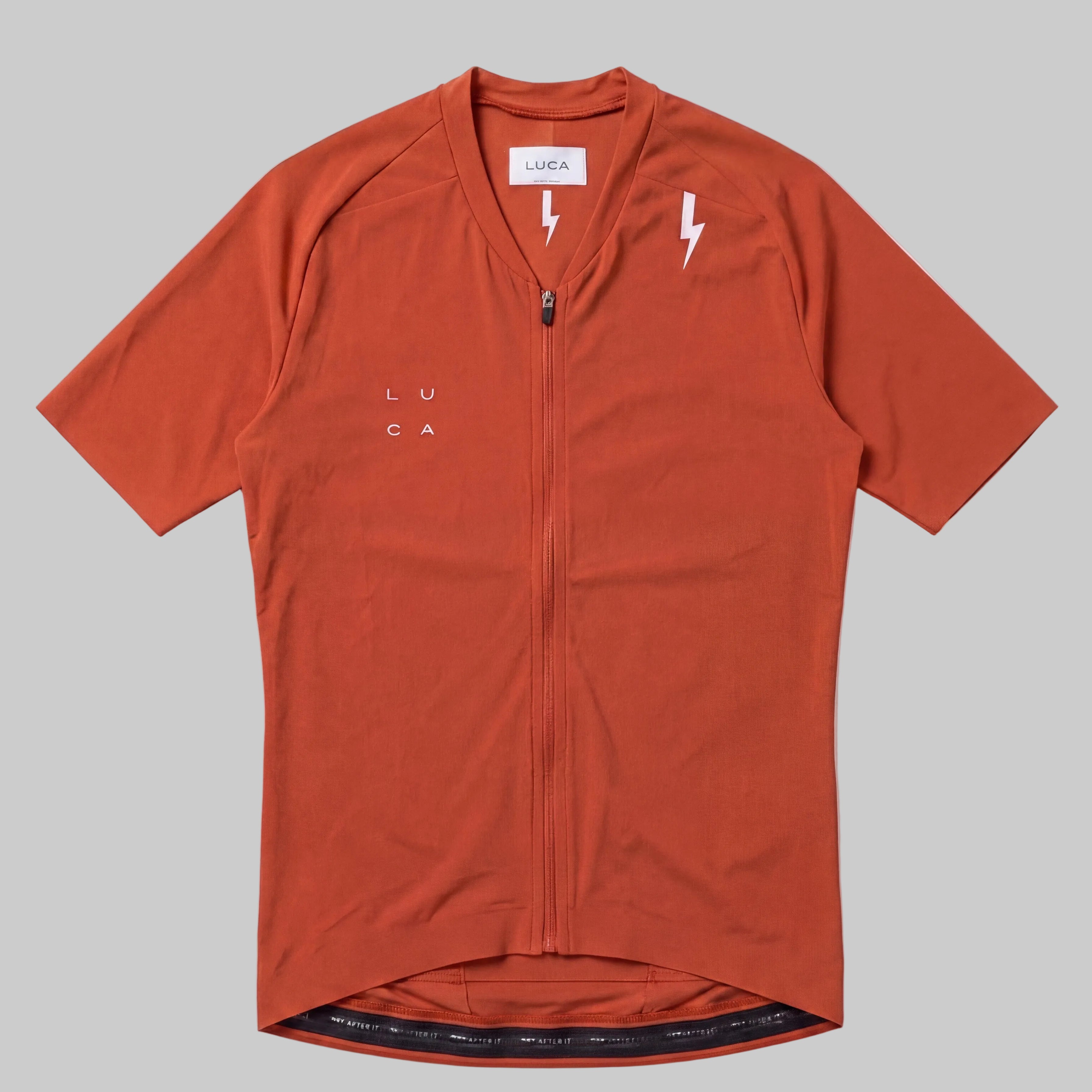 LUCA Soleil women's cycling jersey in aperol - front flat lay with V-neckline and bolt detail