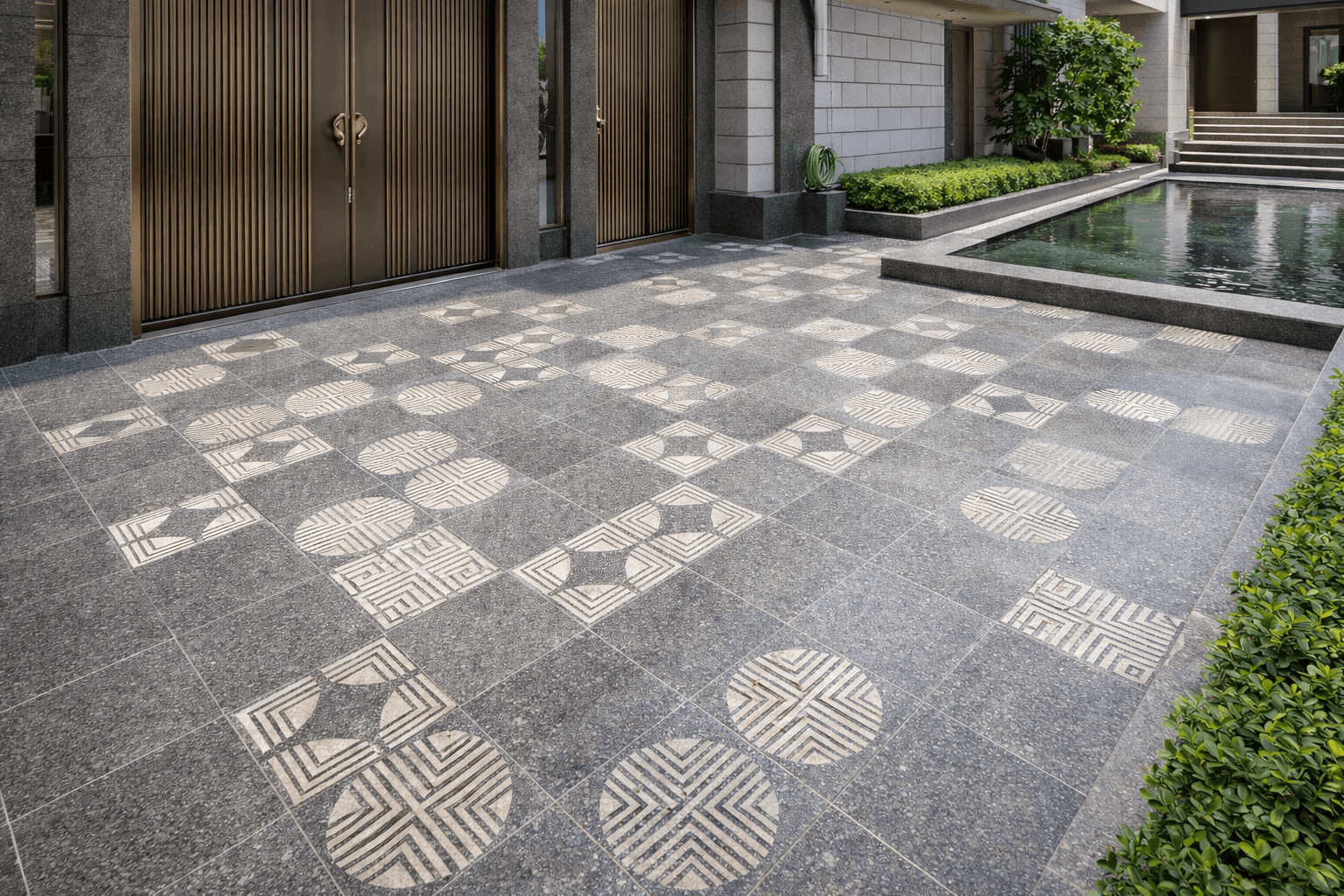 Geometric patterned stone paving used in residential driveway and entrance area