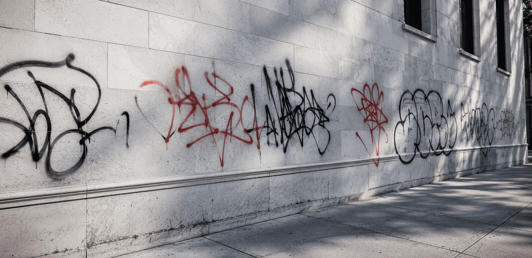 Graffiti-covered commercial wall needing a long-lasting protective coating.