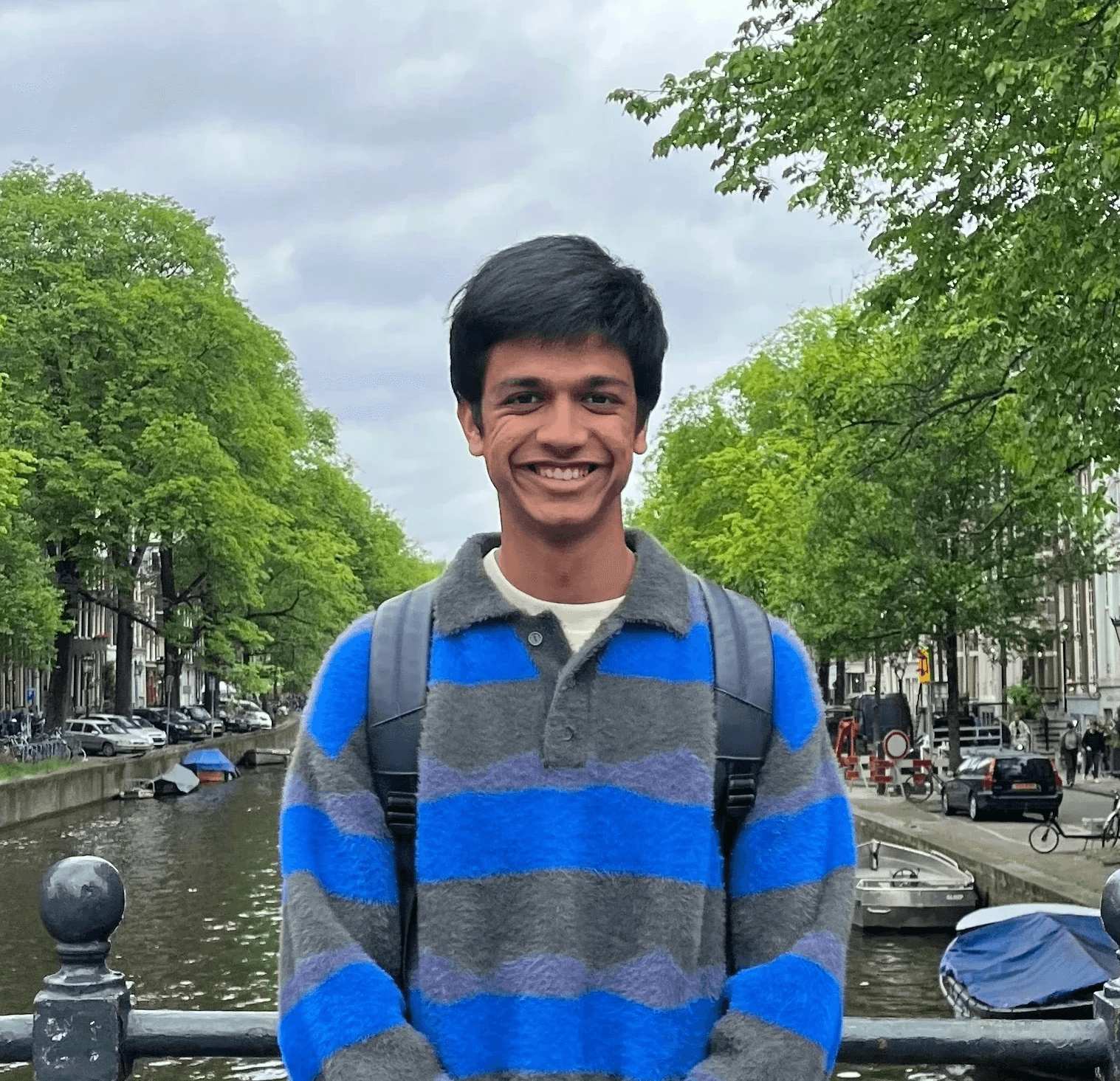 Portrait of a person in dark clothing speaking on a phone