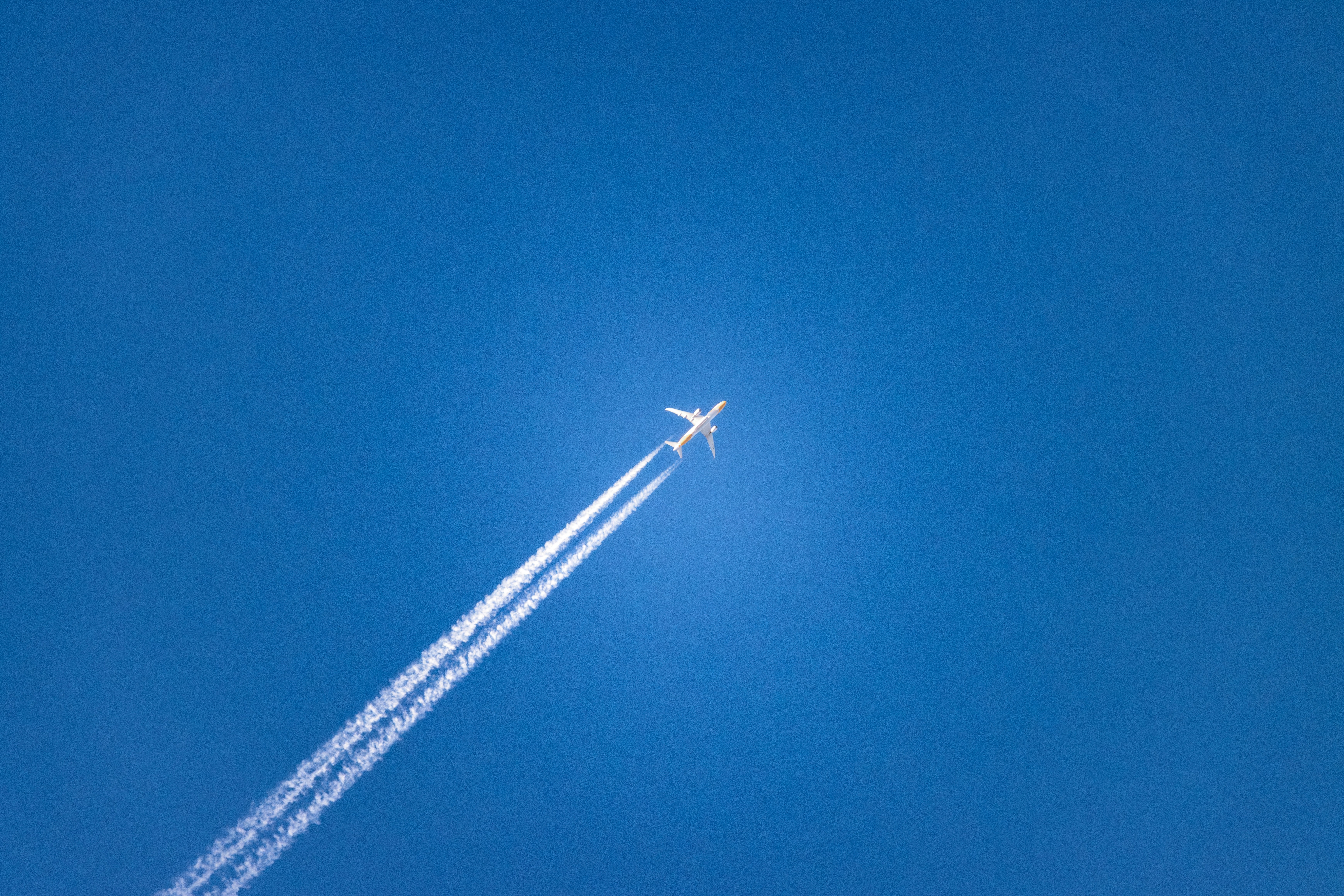 An airplane is flying high in the sky