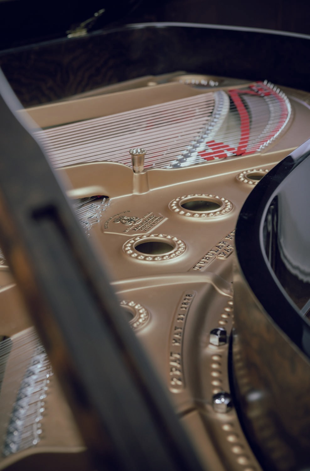 A macro shot capturing the golden soundboard and frame of the restored Steinway & Sons piano.