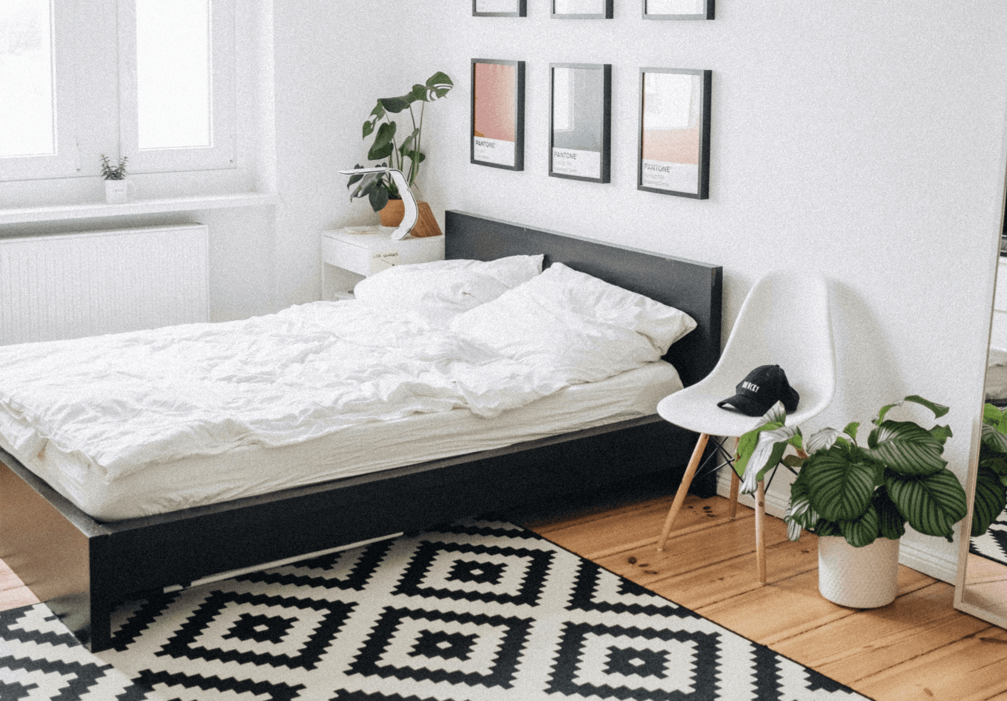 black platform bed with white mattress inside bedroom