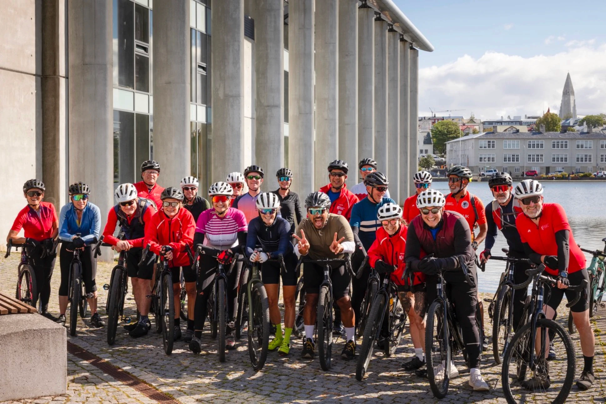 group photo of cyclists in front of town hall