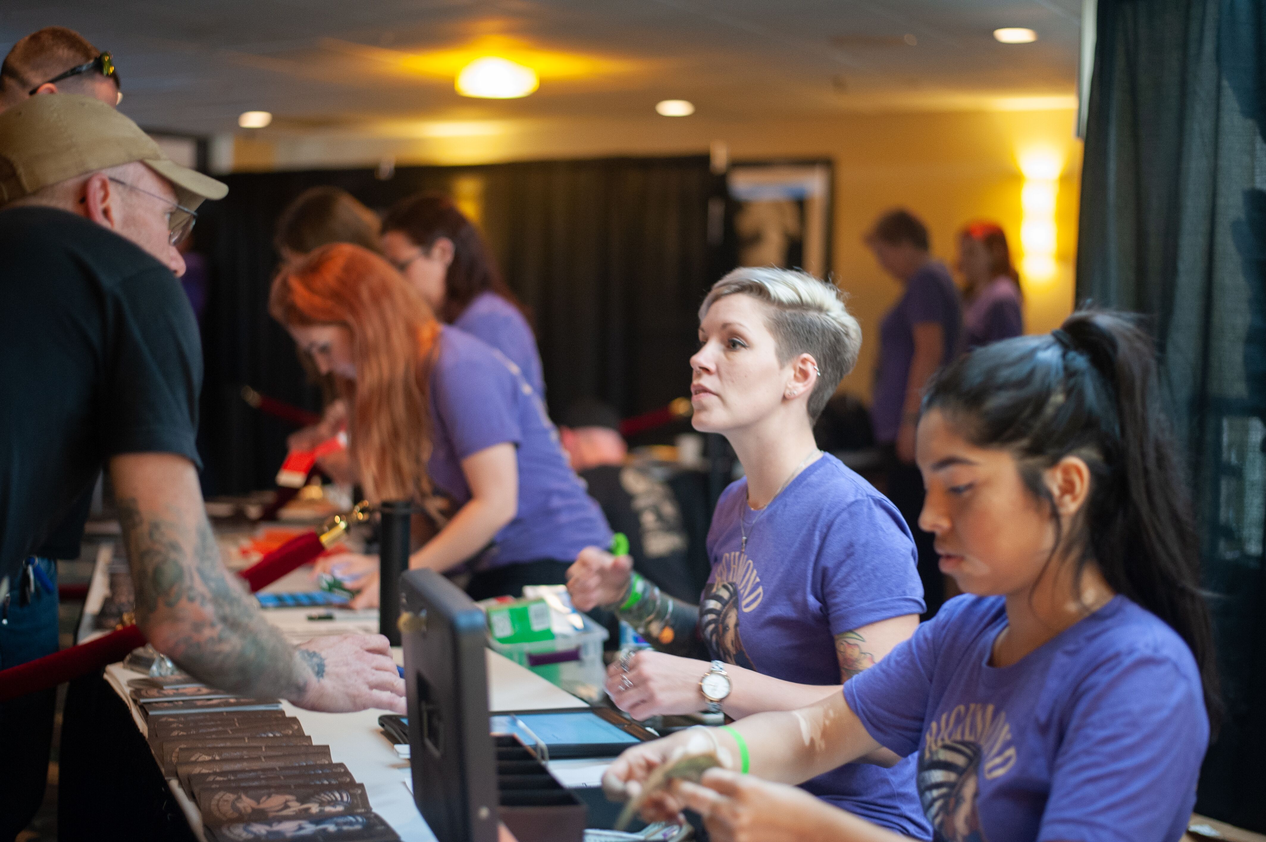 Volunteer at the check in booth at the richmond tattoo and arts convention