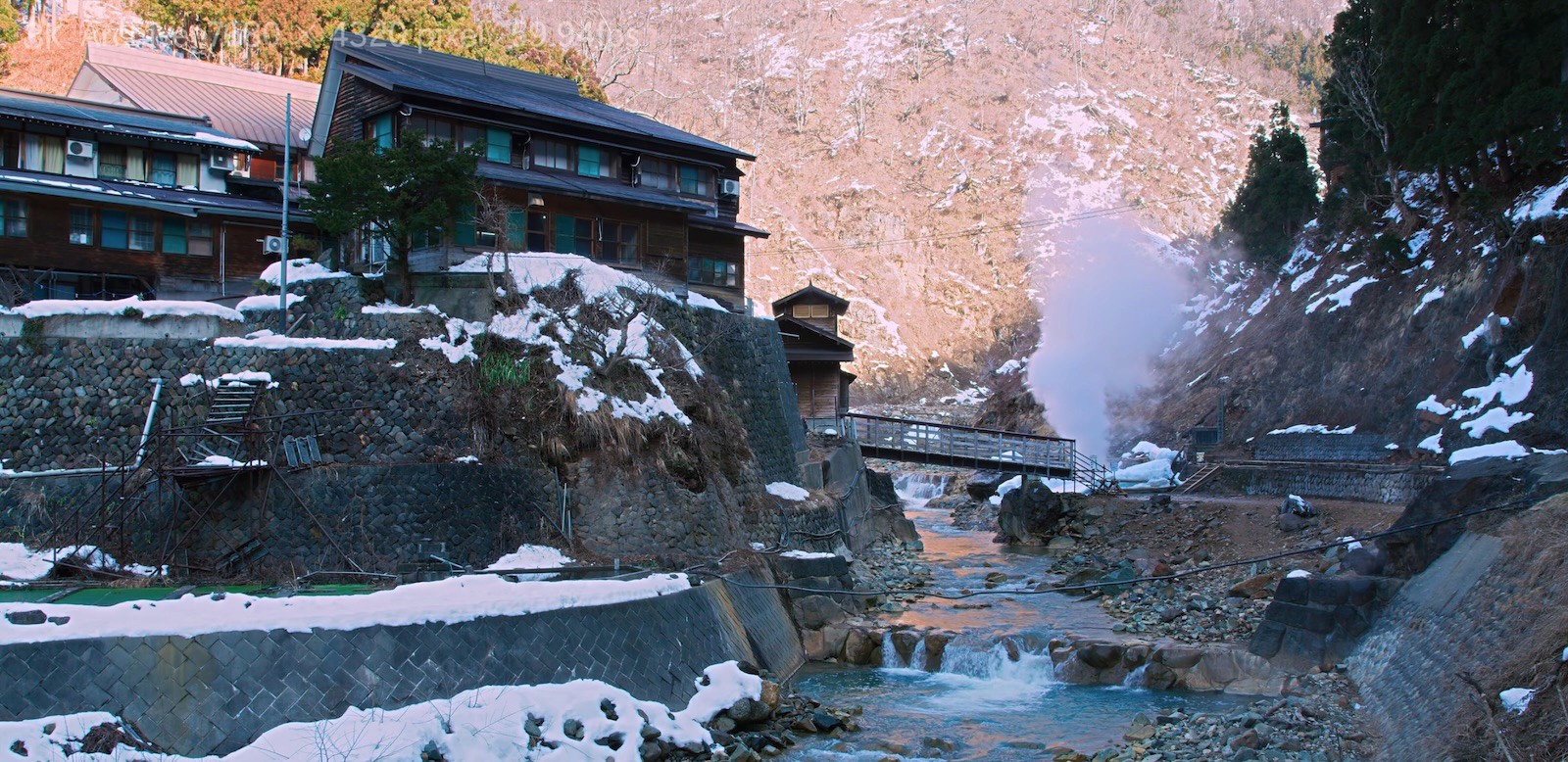 A traditional riverside ryokan in the Jigokudani valley in winter