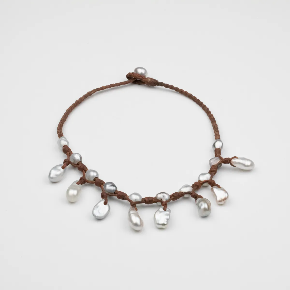 Keshi Pearl choker necklace with nineteen pearls in silver and cream tones on braided brown leather cord with hanging pearl drops — Manos de Oro Saint Barth