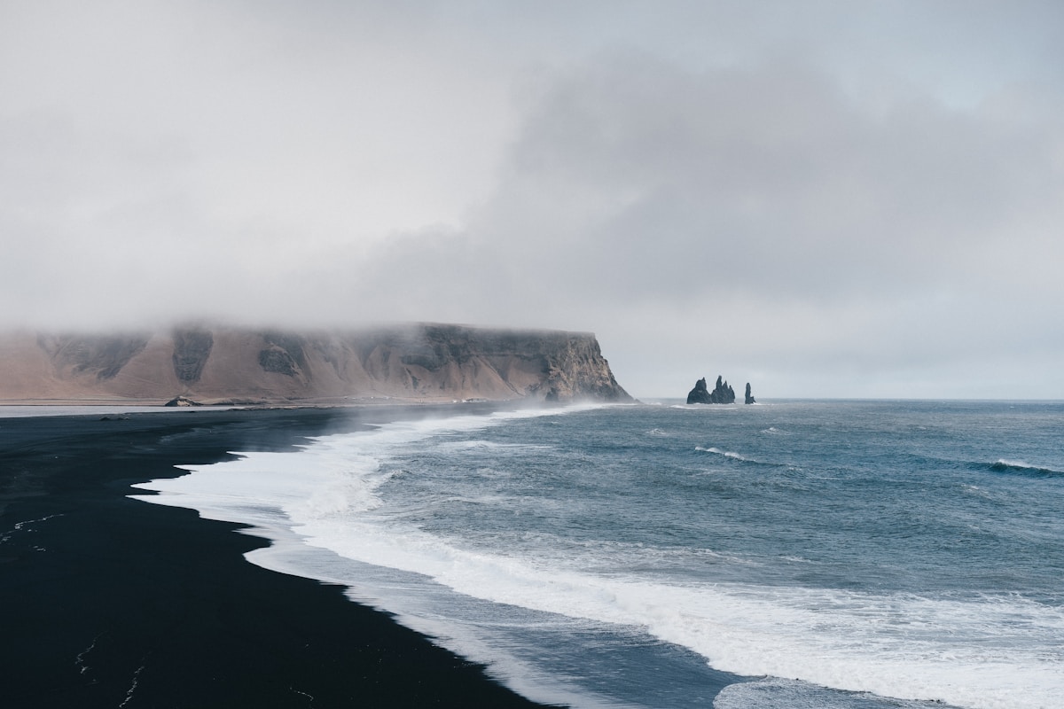 Dramatic black sand beach with waves in Iceland