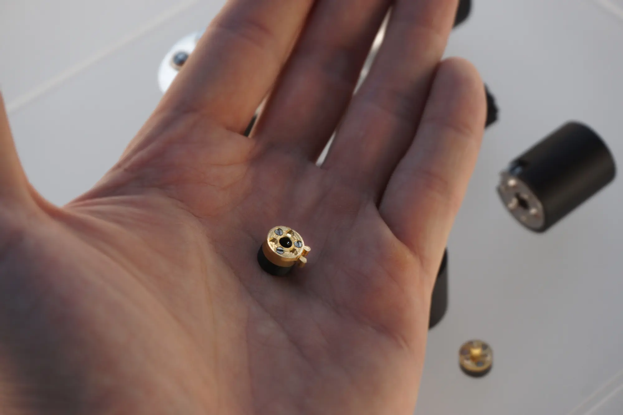 A large group photo of diverse team members gathered in an industrial-style space with arched ceiling.