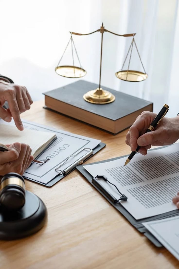 A professional reviewing documents at a desk