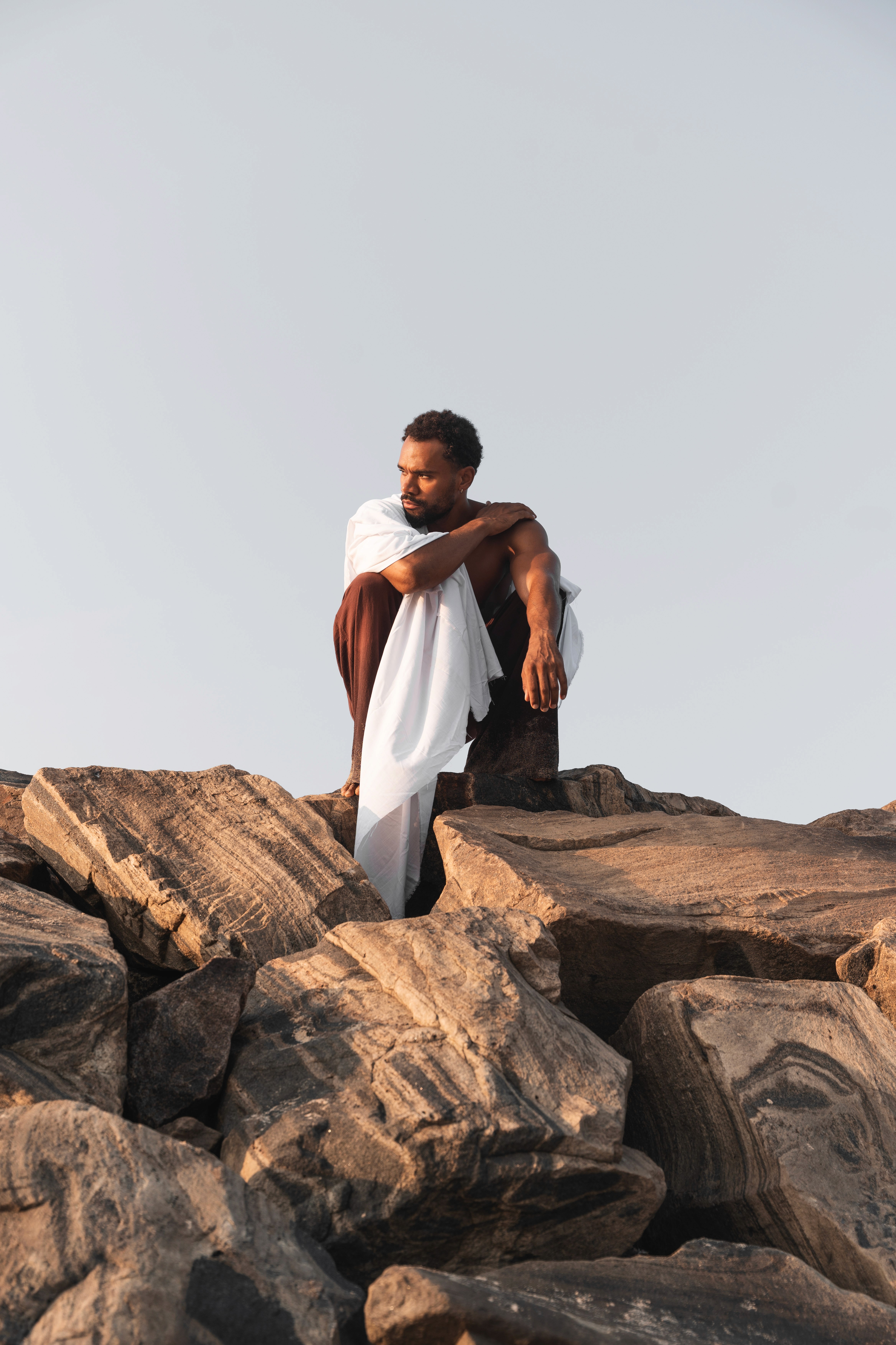 Girl laying on the sand looking to the back 