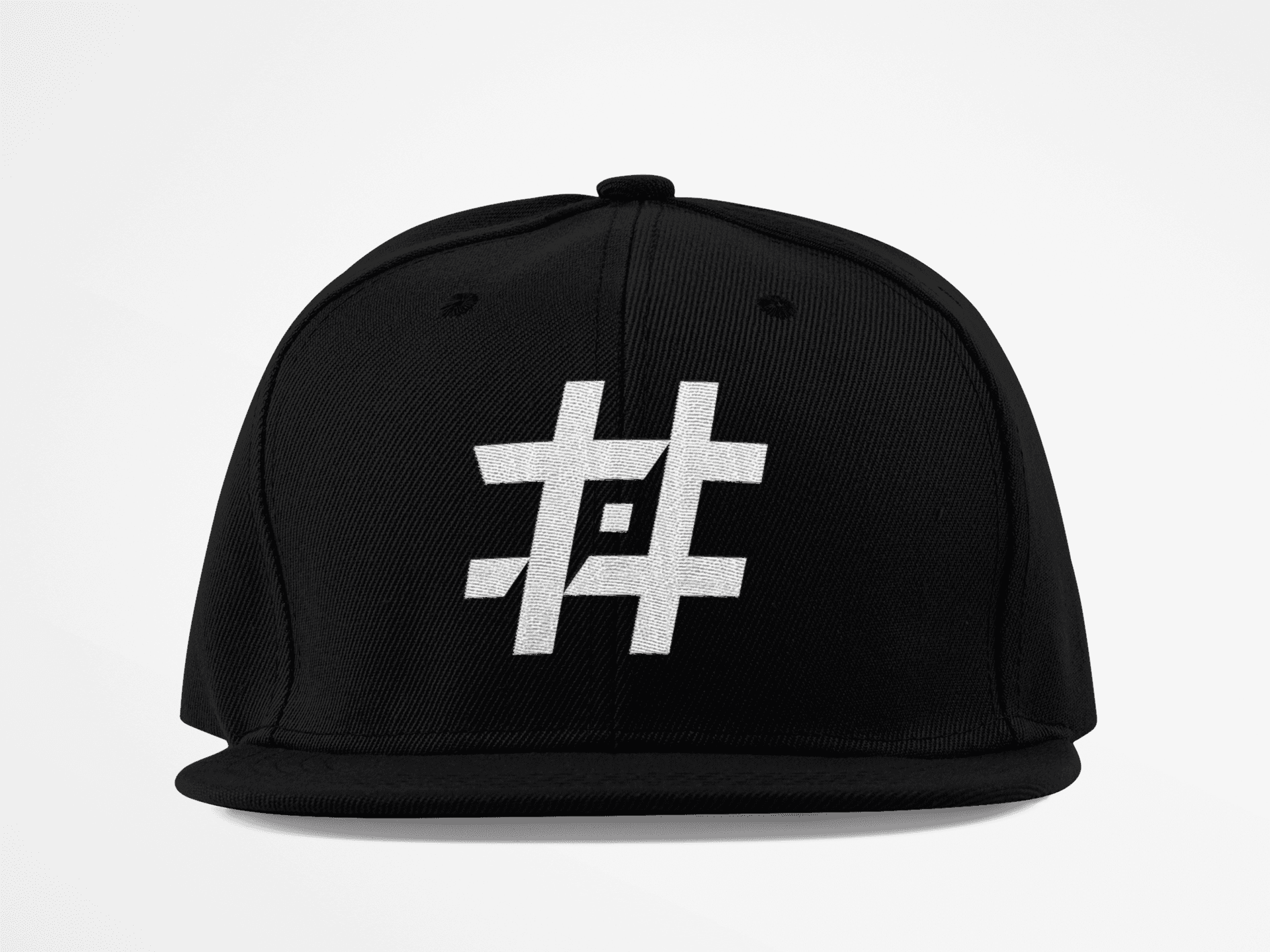 A black baseball cap featuring the '#PrayForHunt' logo prominently embroidered in white on the front panel. The logo consists of a stylized hashtag symbol with a Shuriken element integrated into the design, giving it a unique and dynamic touch. The cap has a structured shape with a flat brim, emphasizing a modern and bold look. The background is plain, allowing the focus to remain on the hat and its distinctive branding.