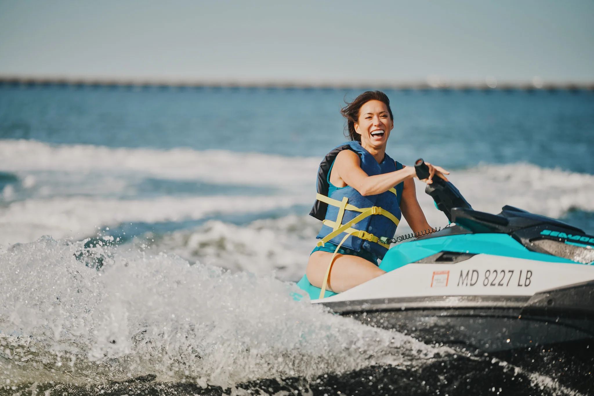 woman laughing on sea doo jet ski — lifestyle photography by Tom Kubik