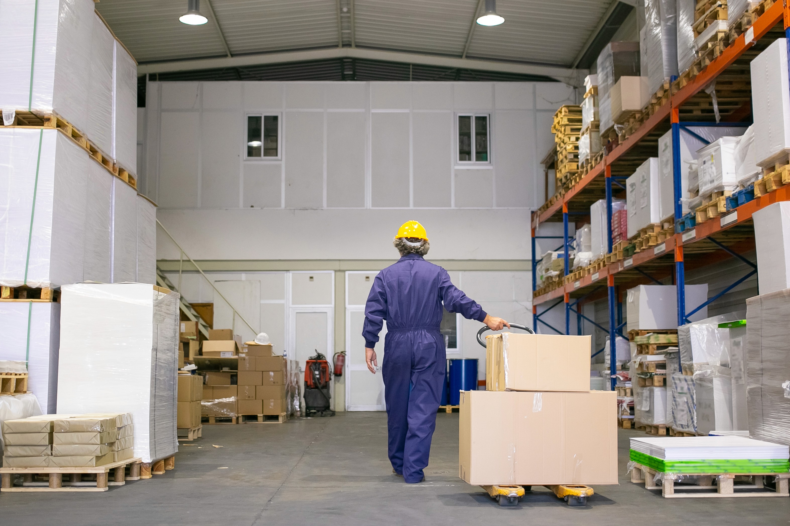 logistics worker moving boxes in warehouse