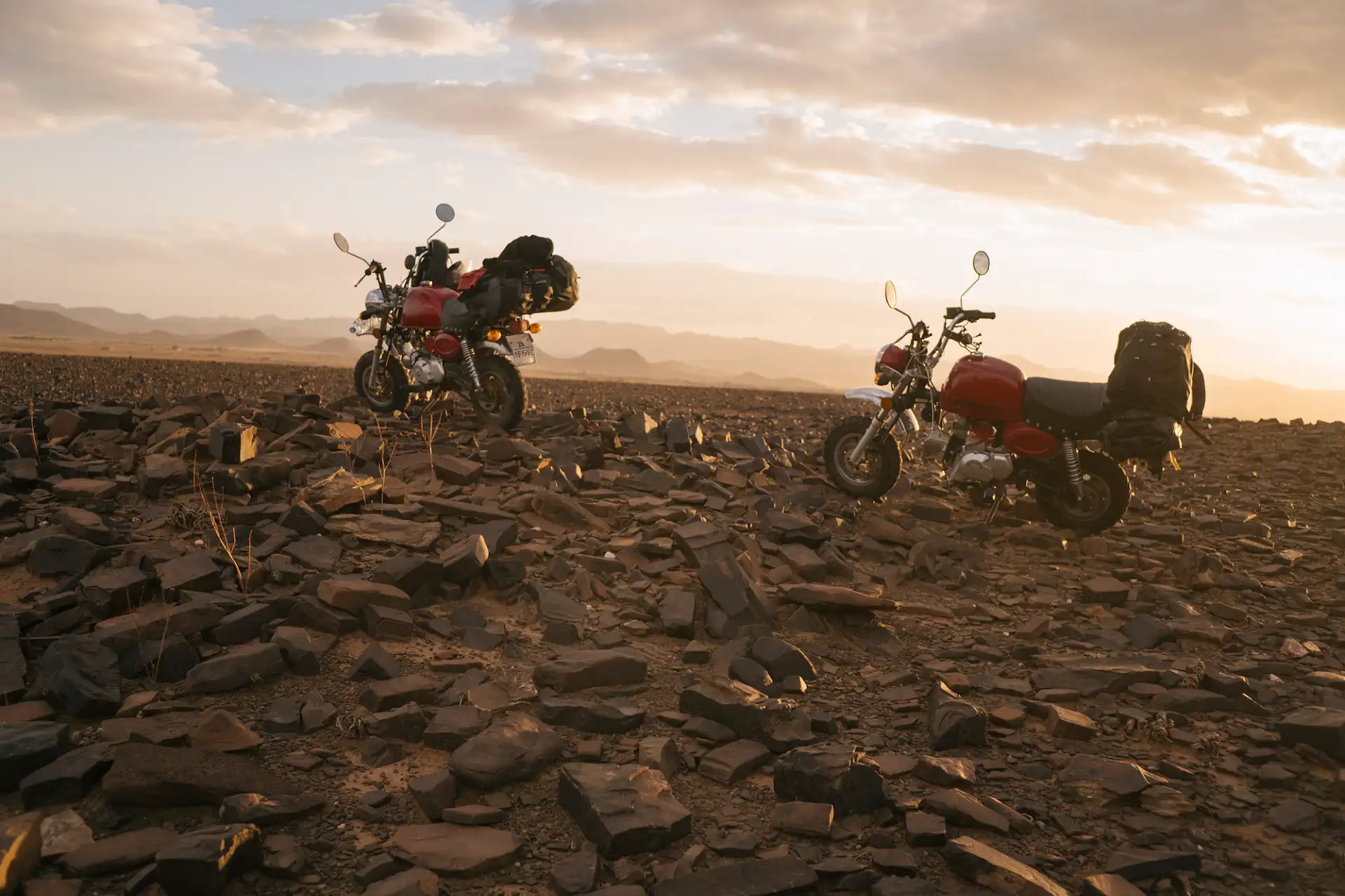 Motorcycles parked on a dry riverbed