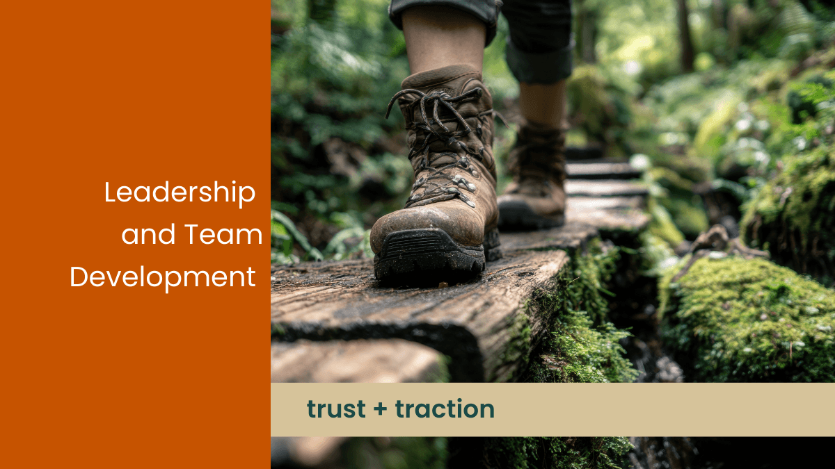 Adventure picture of hiking in the forest that says Leadership and Team Development with the capition trust plus traction