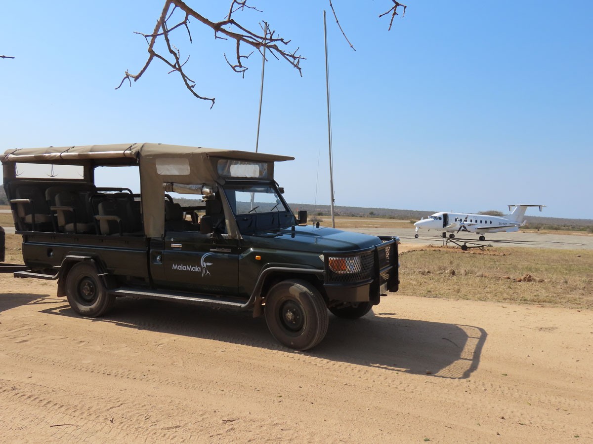 male wearing a black coat with a blue background