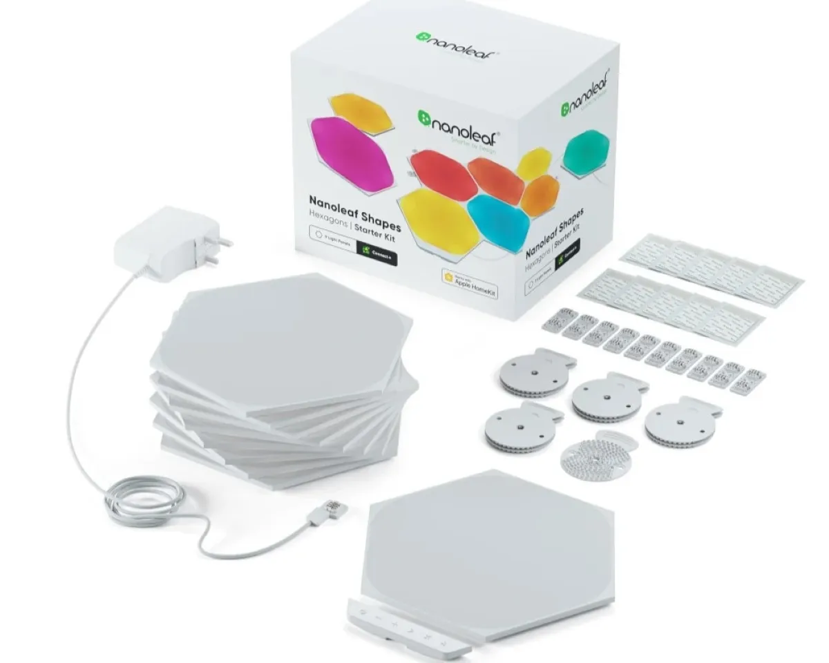 A set of Nanoleaf Shapes Hexagons, featuring stackable hexagonal light panels, a white power adapter, connectors, and mounting materials against a white background, with a colourful product box displaying the brand logo and vibrant hexagon shapes.