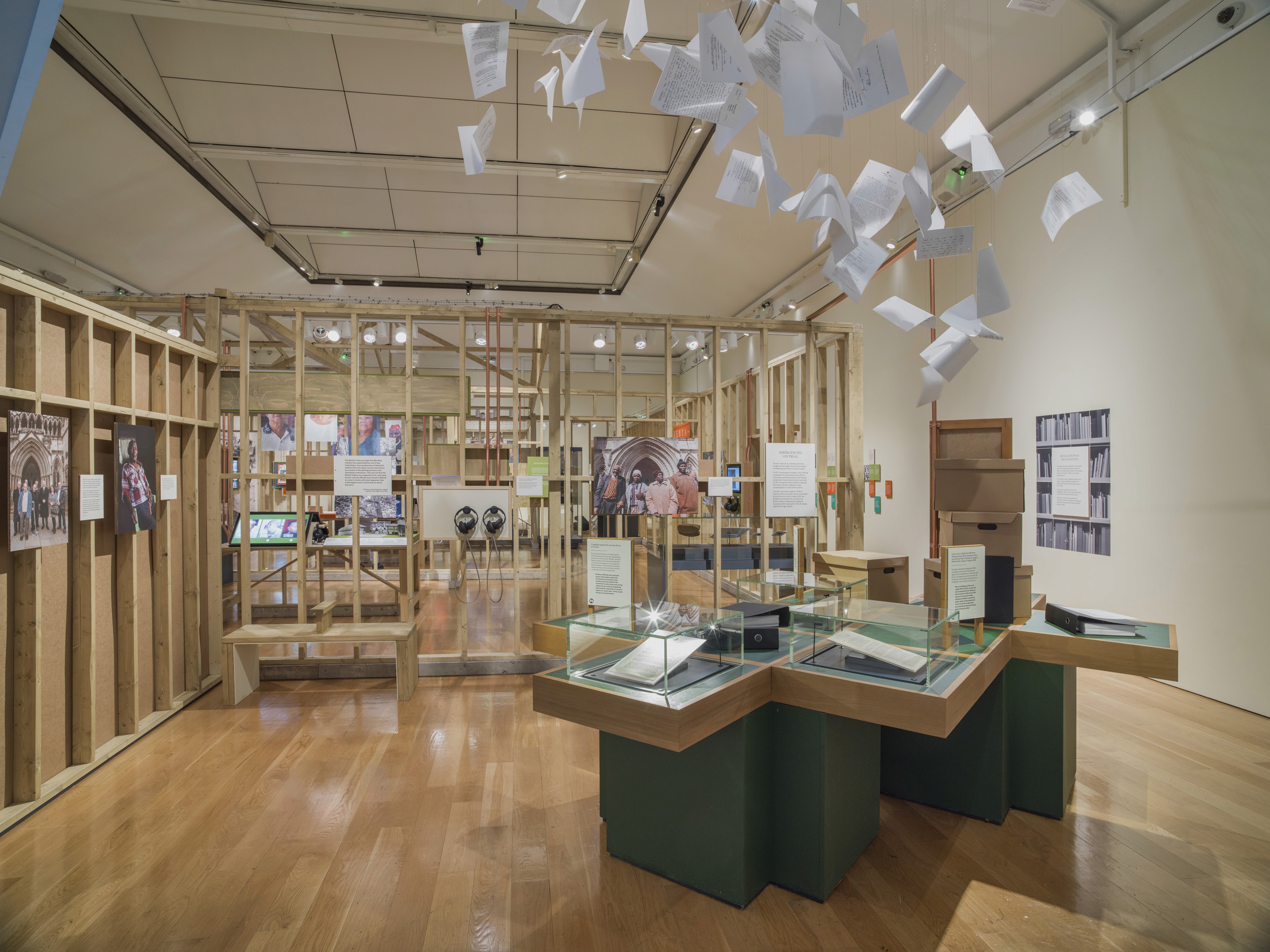 A modern outdoor space with sleek black features surrounded by greenery and tall buildings in the background.