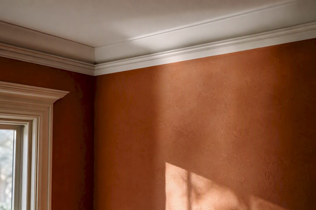 Shadows cast by crown and cove moldings on ceiling