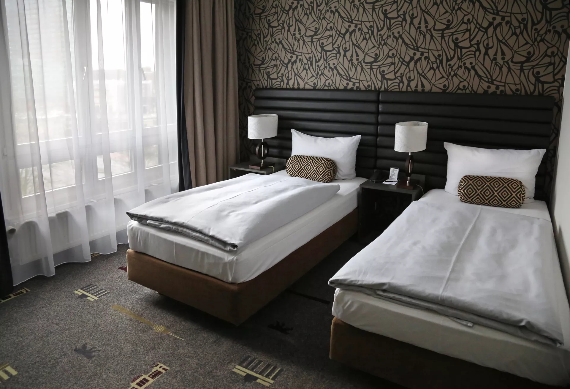 nfinity pool blending into the ocean view, minimalist sun loungers in soft neutral fabric, curved architecture