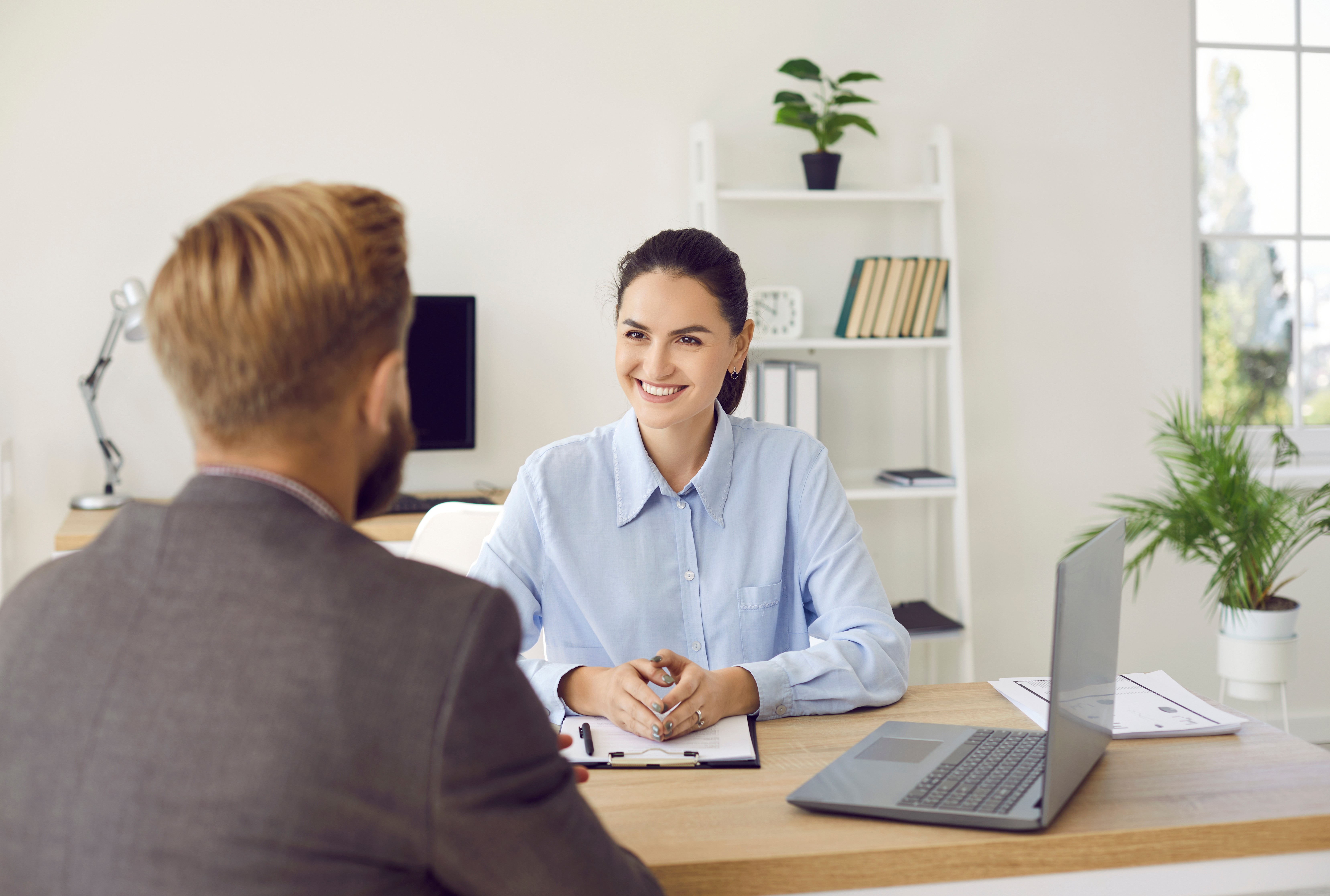 A man and woman have a meeting where they discuss how SwissFx can support the client