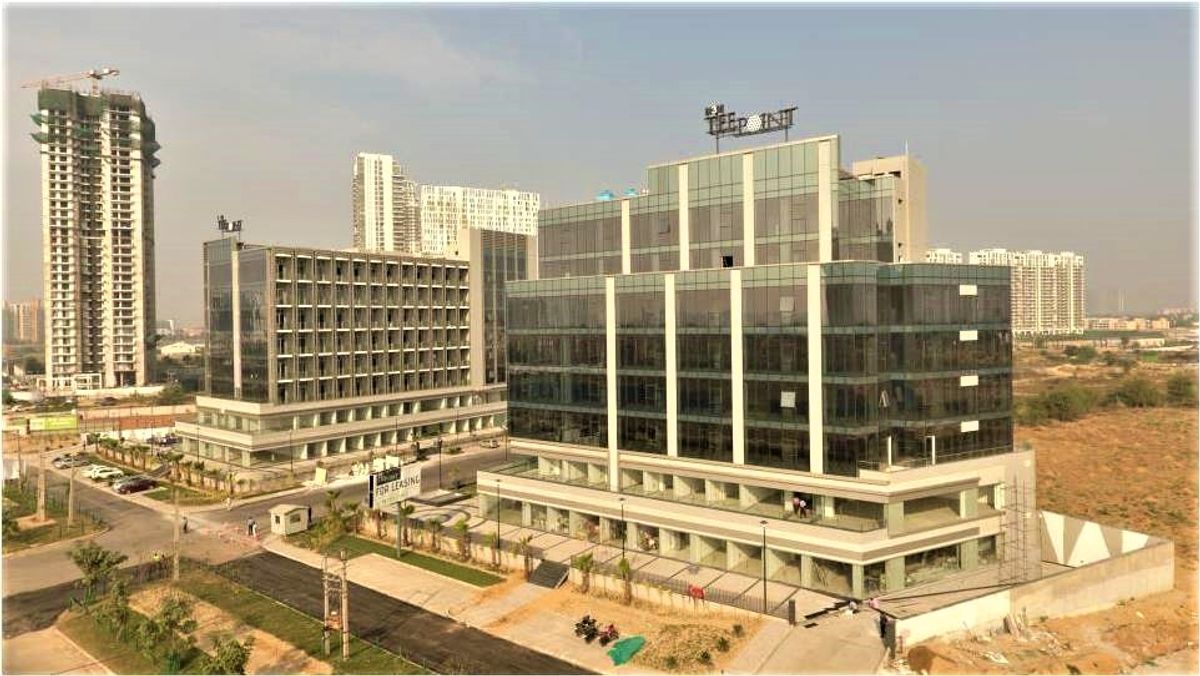 High-street retail shops and modern office spaces on Golf Course Extension Road