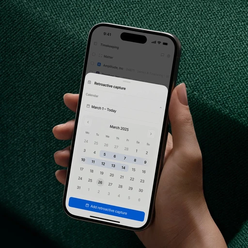 A hand holds a smartphone displaying a "Retroactive capture" calendar for March 2025, a key digital product feature.