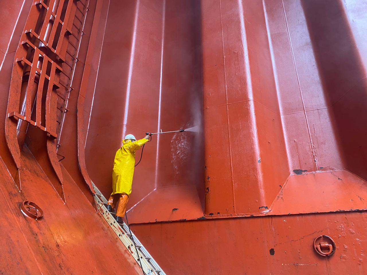 a large cargo ship in the water next to a dock