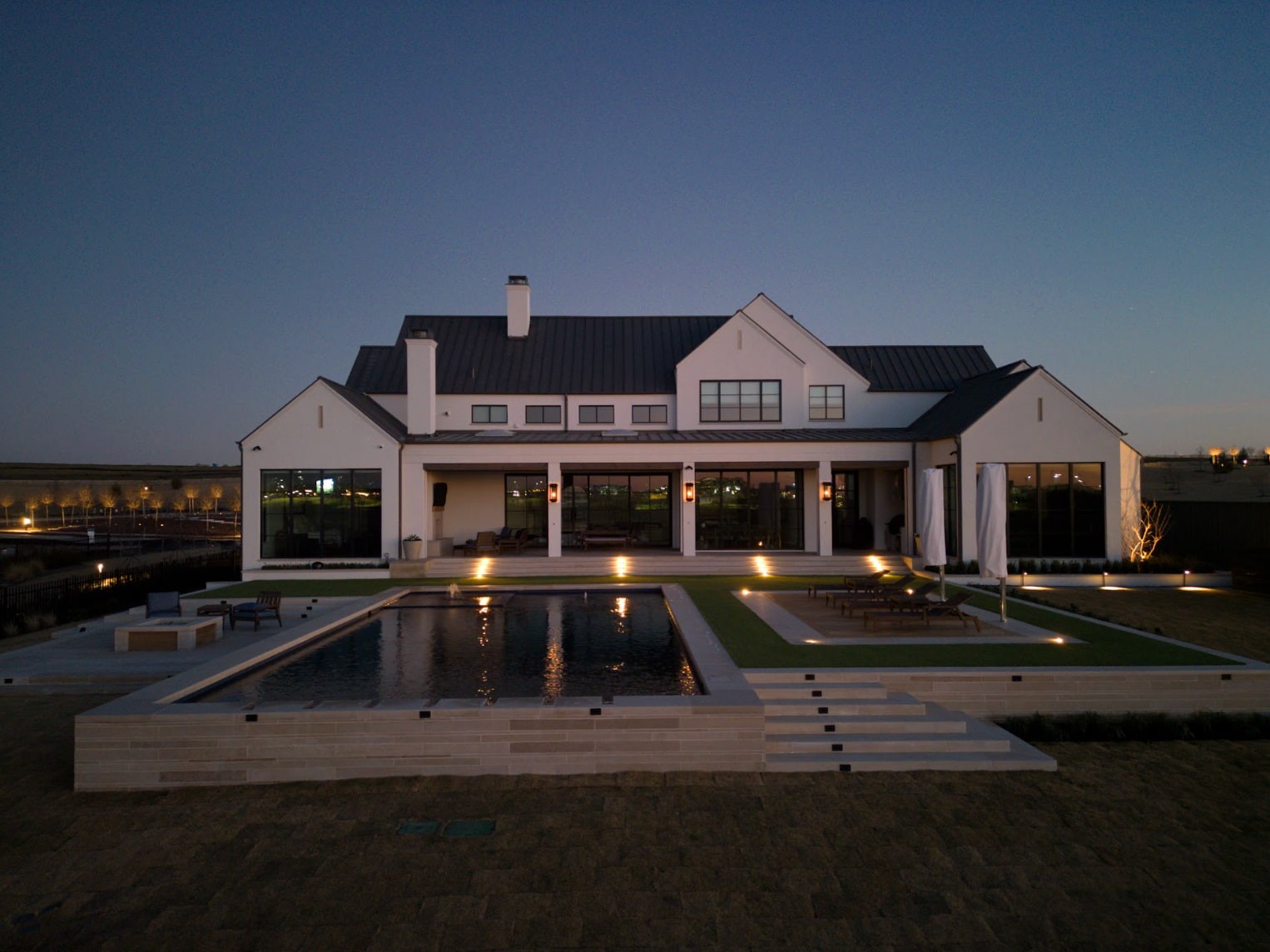 Full home view at golden hour of luxury landscape and home. Designed and built by Blount Designs and Alford Homes, Frisco TX